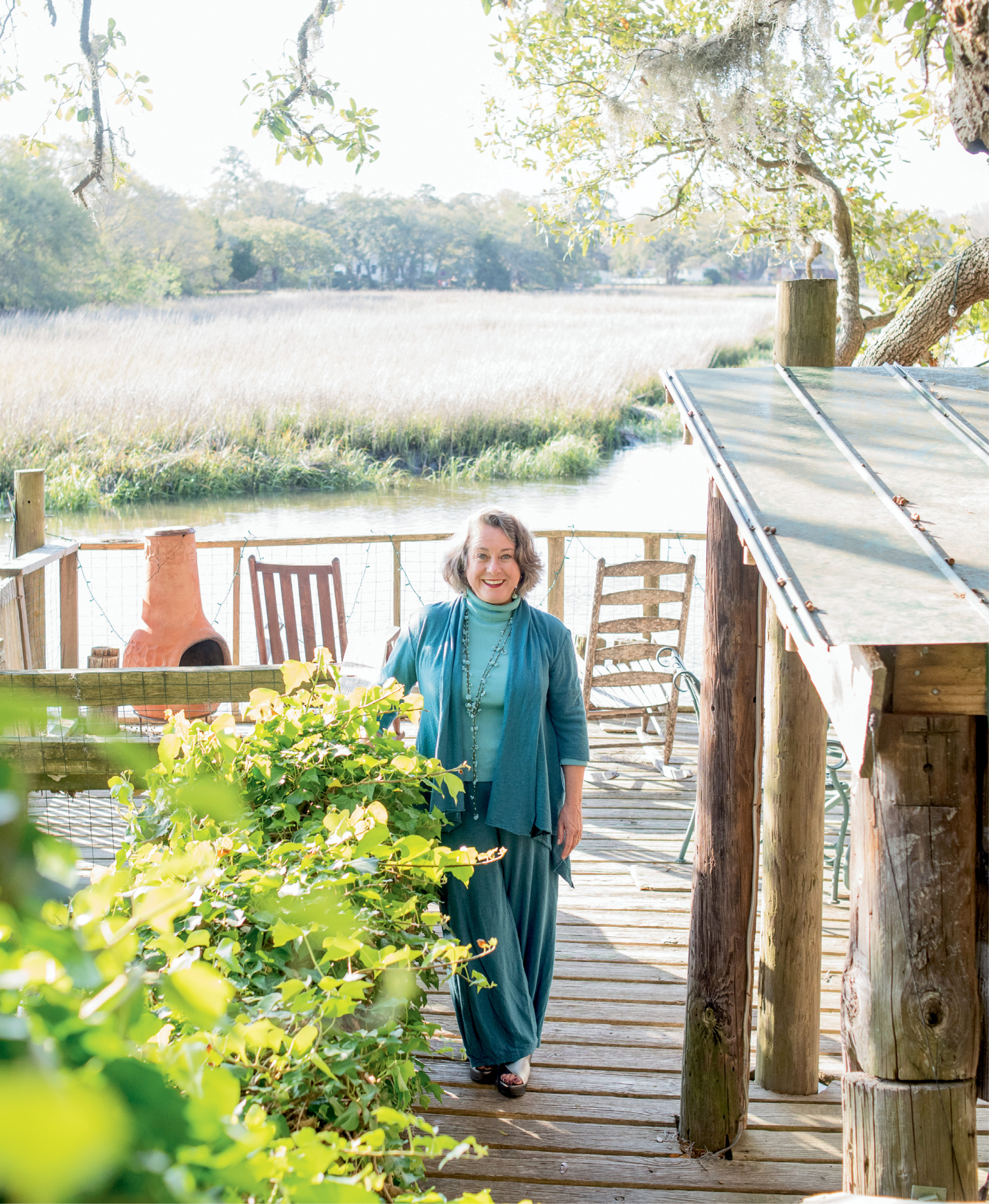 “I love to be outdoors,” says artist Mary Edna Fraser, pictured here on the dock of the James Island tidal creek property where she lives and works.