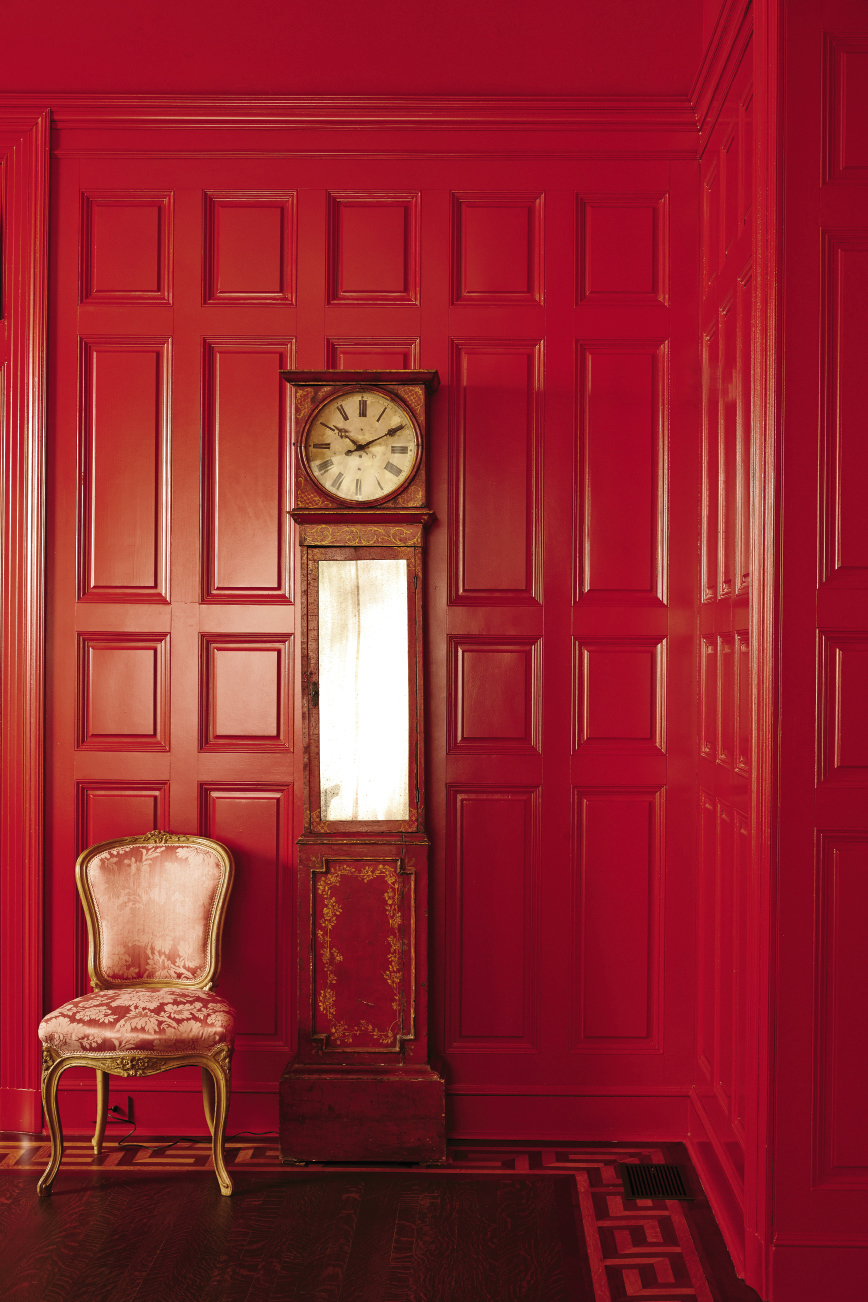 A rich, warm red jazzes up the formal paneling in the dining room.
