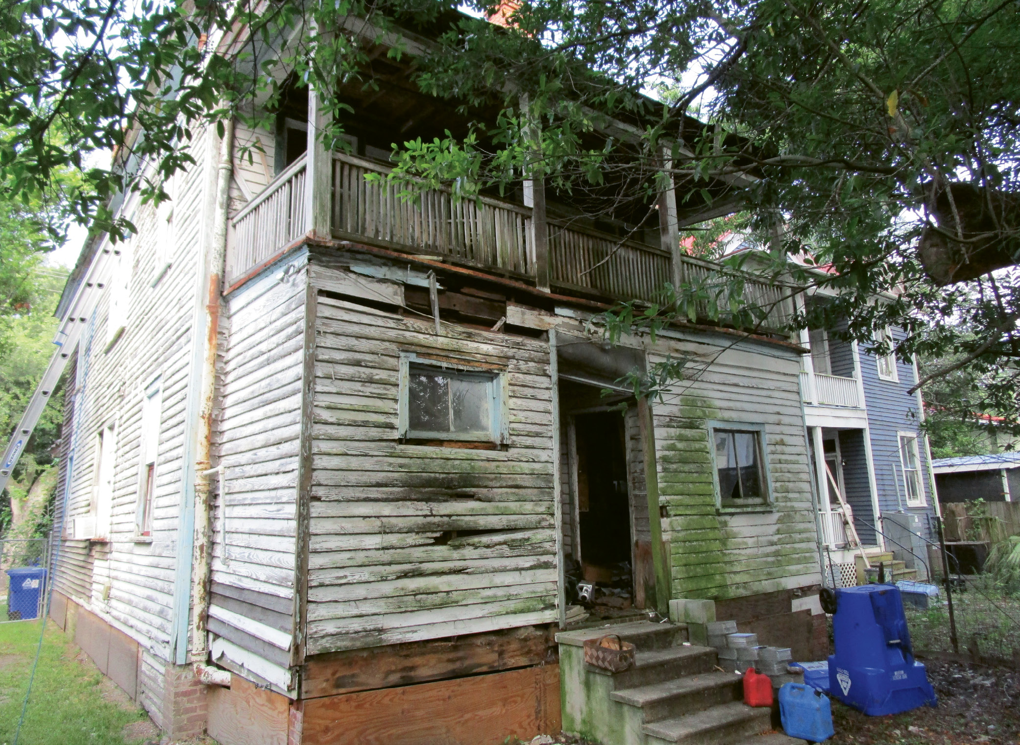 Before: During the renovation, the rotting back porch that had been closed in at some point was removed from the rear facade.