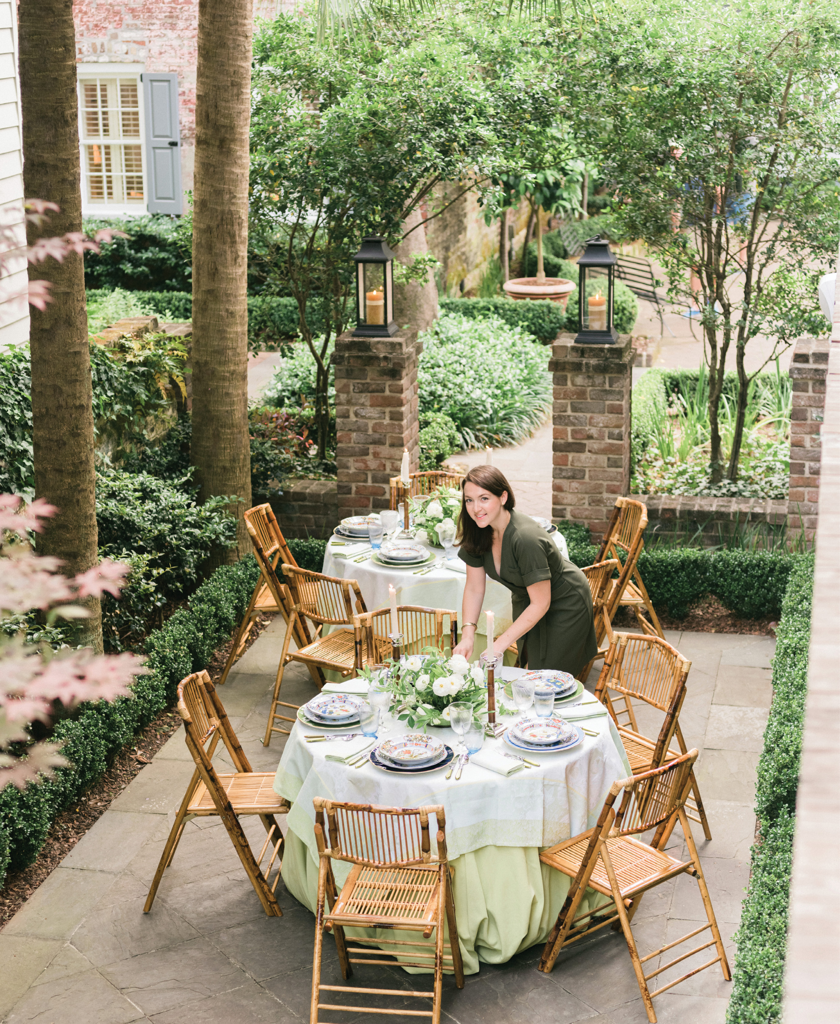 Augusta Cole, Lynn’s right hand at Easton Events, puts the finishing touches on the tables. “I chose two rounds to break up the long, narrow space,” Lynn explains. “I love creating intimate dinners, and nothing does that better than a 48-inch table.”