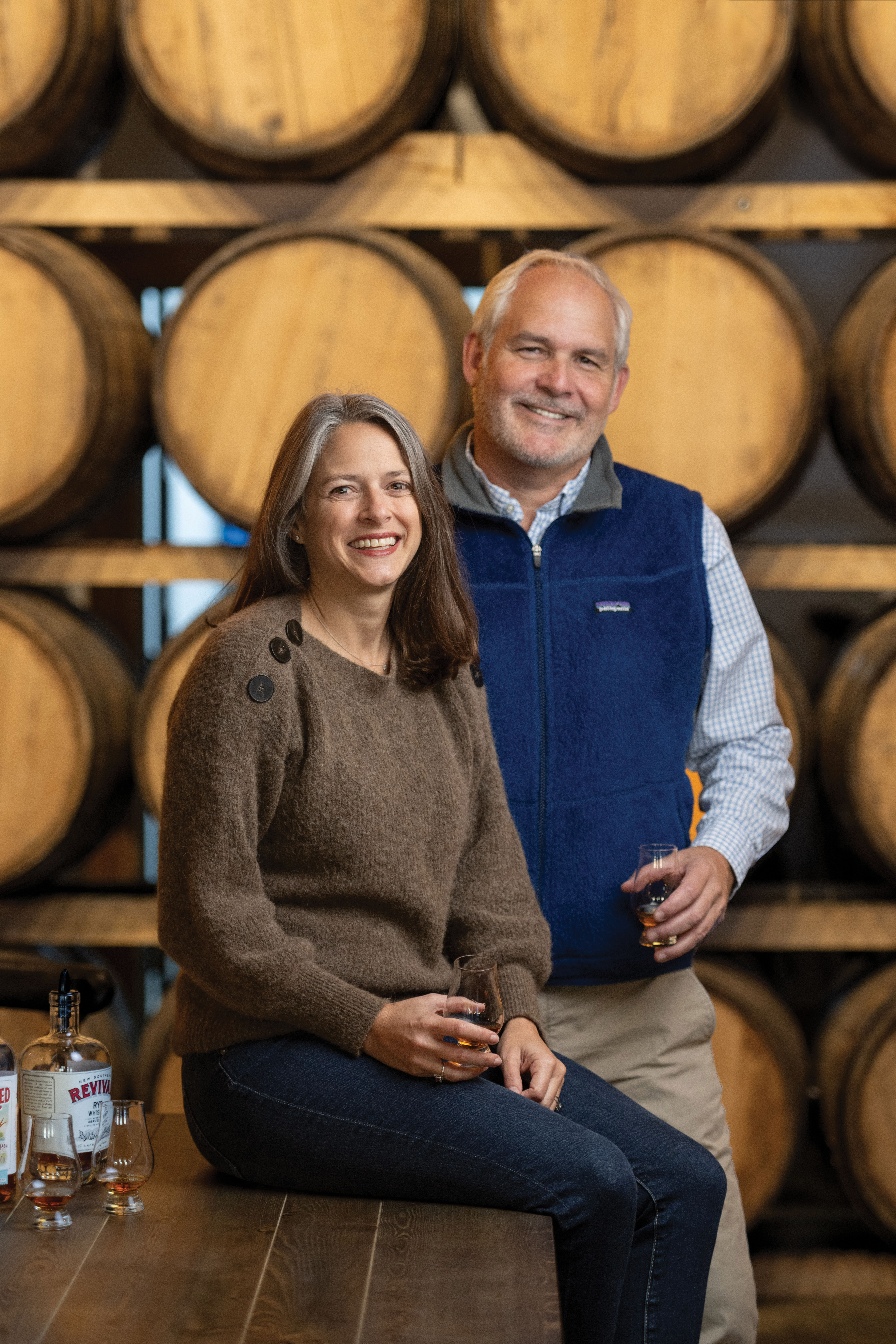 Cheers! High Wire founders Ann Marshall and Scott Blackwell at their Huger Street distillery and tasting room; the couple celebrated the 10th anniversary of their award-winning, small-batch spirits company last fall.