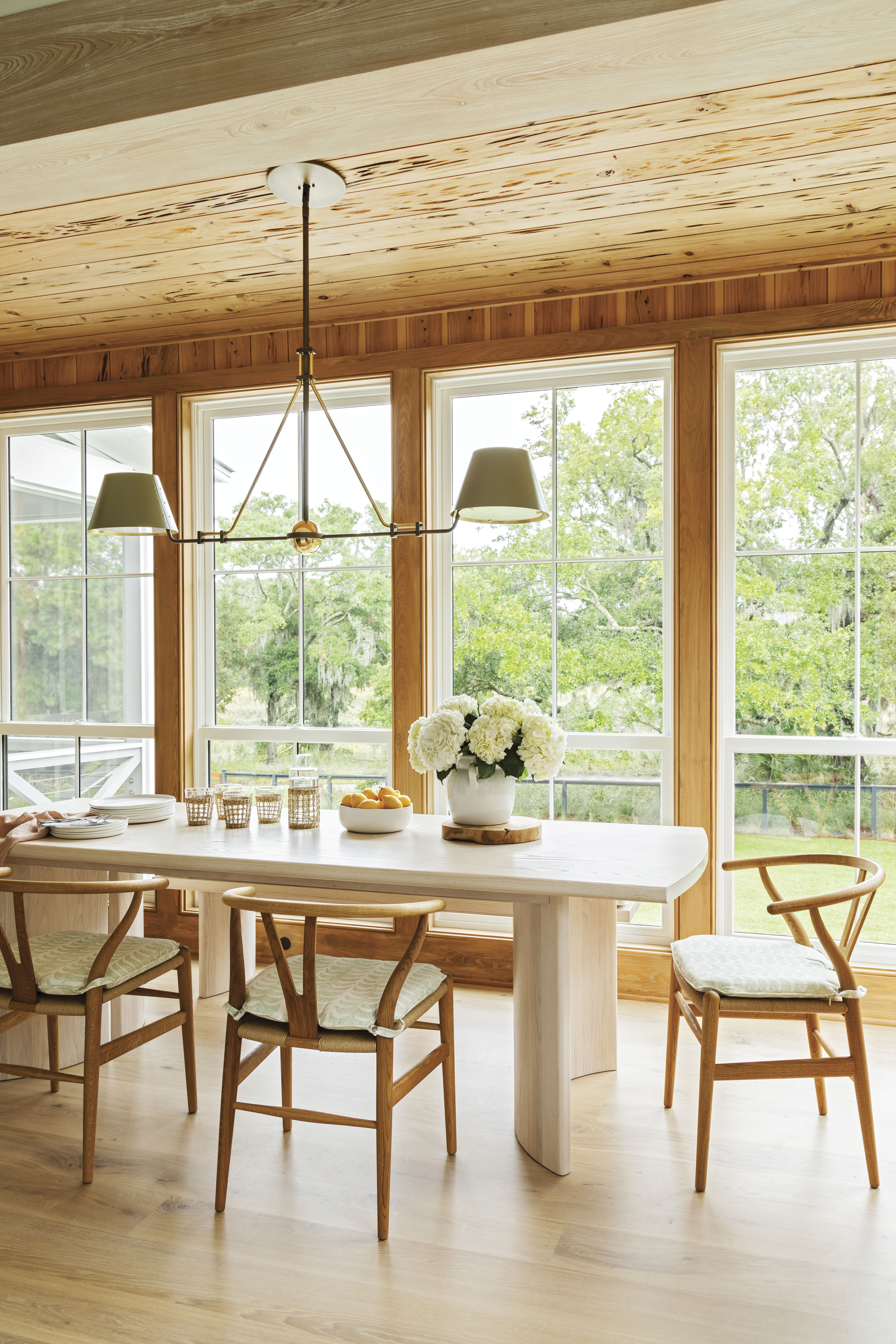 Natural Selection - When your backyard hosts spartina and live oaks, roseate spoonbills and dolphins, it’s best to let nature take center stage. To complement—but not compete with— the view, architect Beau Clowney filled this dining nook with floor-to-ceiling windows, and interior designer Allison Elebash covered both walls and ceiling in pecky cypress planks.