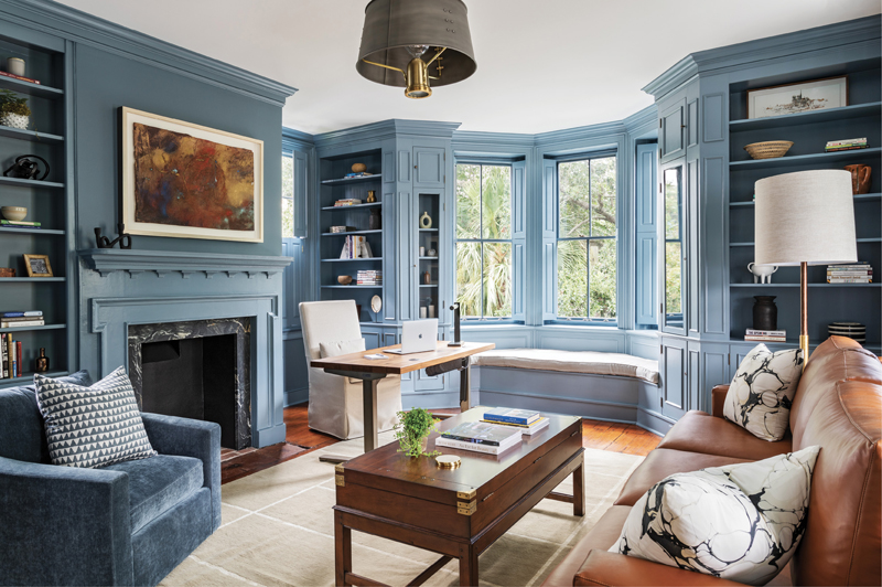 Blue Hues: The second-floor library has become Amir’s office with walls and woodwork painted in a custom blue. Another Horton artwork resides over the sitting area with custom mohair chairs, sofa from Edelman Leather, and rug from Tufenkian Artisan Carpets.