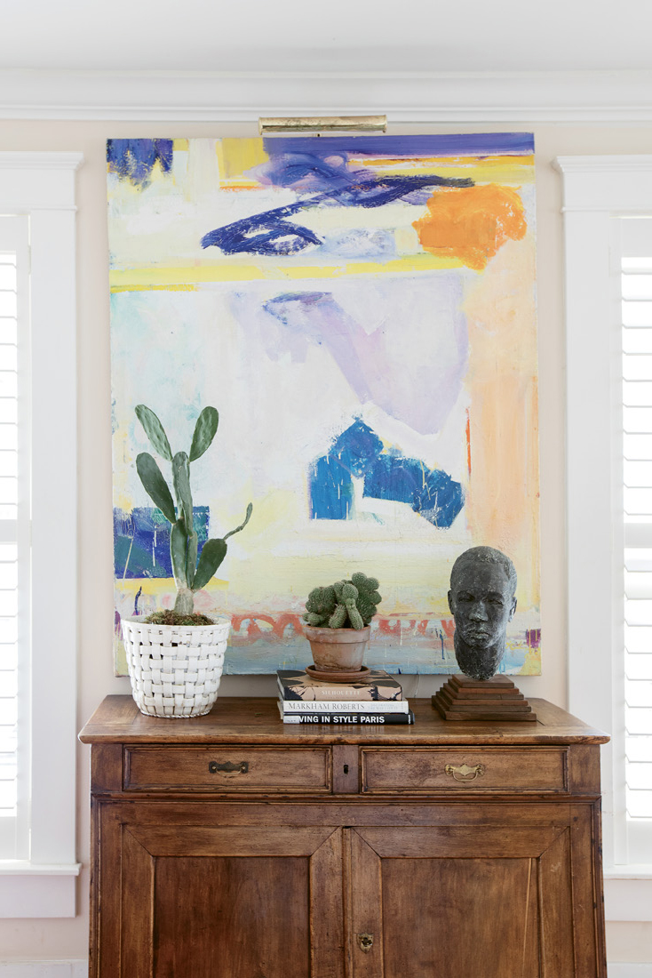 Art Works: An abstract painting by California-born artist Frank O’Cain is a wash of color in the family room. Debbie likes to juxtapose contemporary art with the vintage and antique furnishings.