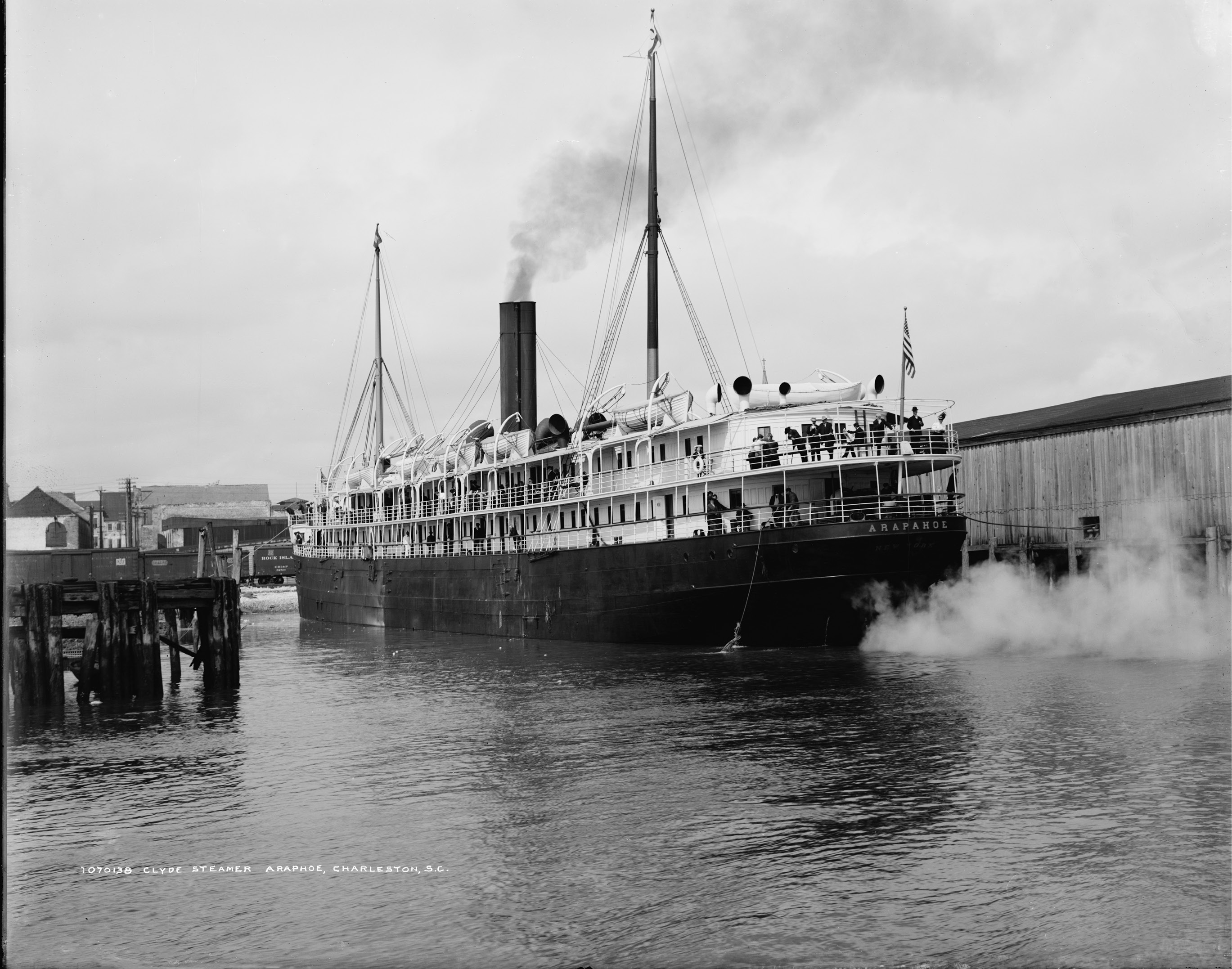 The Clyde ships ran regularly between Charleston, Philadelphia, and New York, docking at the wharves at the foot of Queen Street. The amenities they touted included cabins finished in oak; an exceptionally attractive social hall ”finished in cream and gold, having an upright piano, velvet cushioned sofas;” and the most modern invention of all—electric lights throughout. Clyde Steamer Arapahoe, circa 1900, from Detroit Publishing Co.