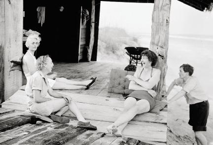 Relaxing with friends, circa 1938, at the Grass Shack at Hobcaw Beach that her former companion Barbara Donohoe had designed