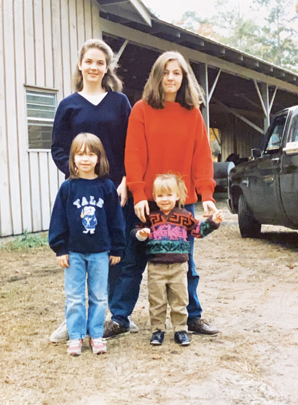 Ceara with her sisters, (from left to right, clockwise) Inanna,  Naomi, and Aidan at the stables, around 1985.