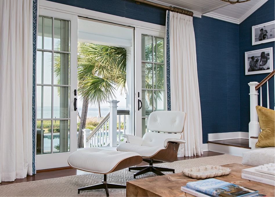 ARMCHAIR TOURISM: Strategically positioned near French doors that lead to the patio, this Eames lounge chair and ottoman provide a sleek yet comfy perch for taking in views of the pool and the Atlantic.