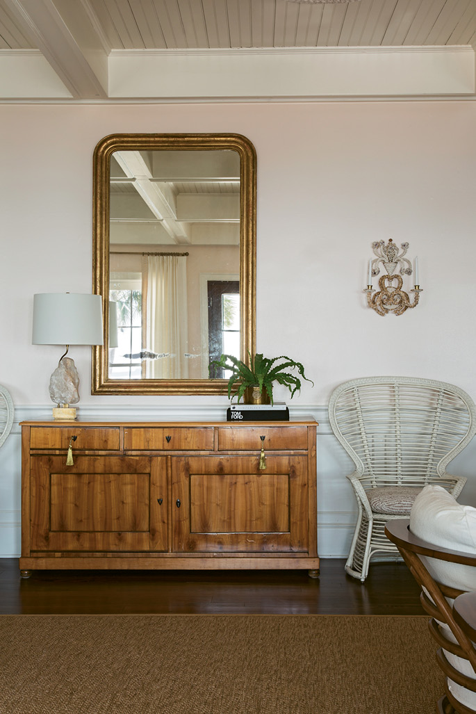 NATURAL ACCENTS: The use of natural materials, such as sisal area rugs and the cherrywood of the circa-1825 Biedermeier chest, underscore the home’s connection with nature.