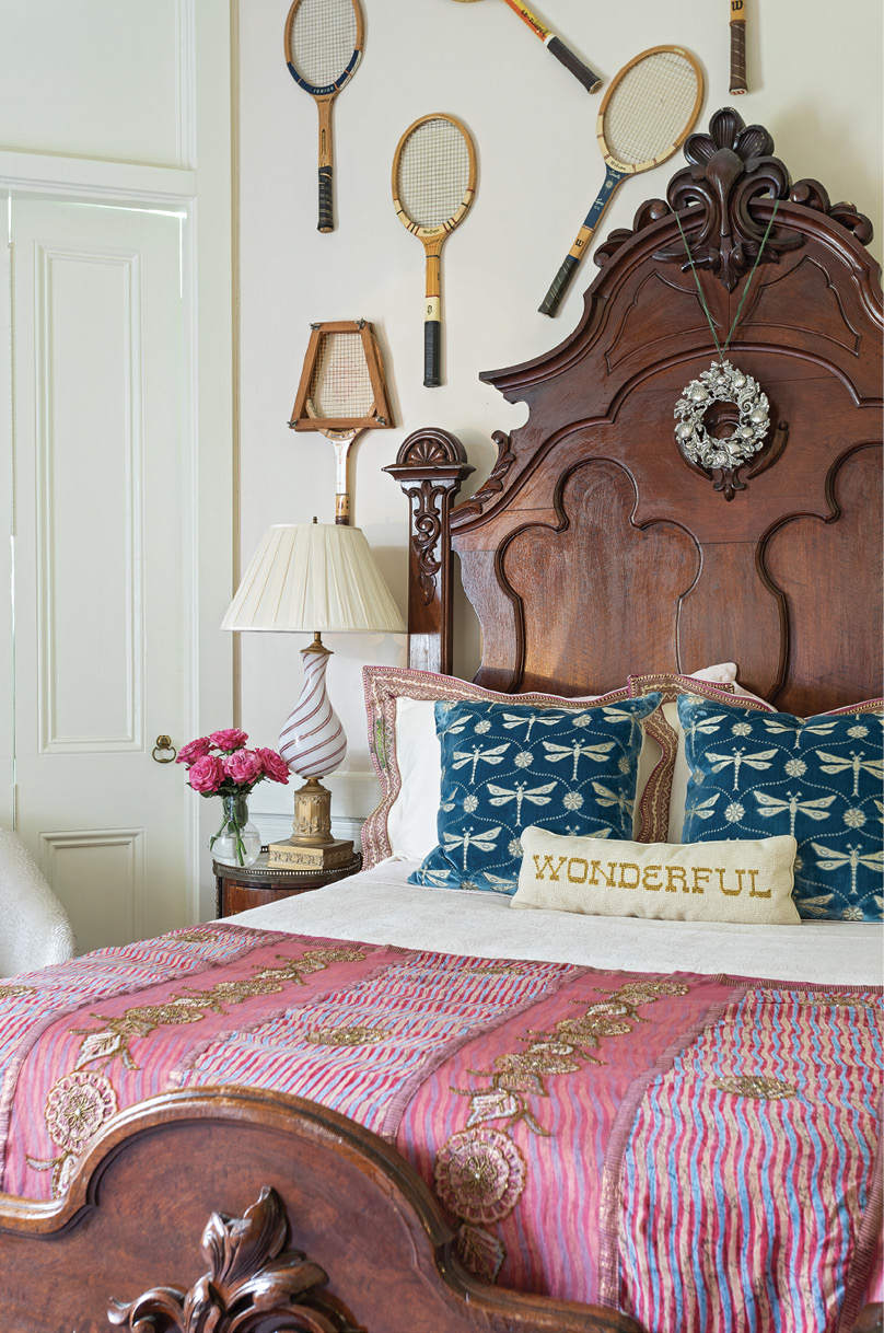 Tennis, Anyone? The couple’s daughter, an avid tennis player, decorated her Victorian-era bed with a vintage racquet gallery wall. Ralph added small round bedside tables from 17 South Antiques to fit in with the unusual hexagon shape of the room. Two decorative dragonfly pillows from Antiques of South Windermere provide a playful pop of color.