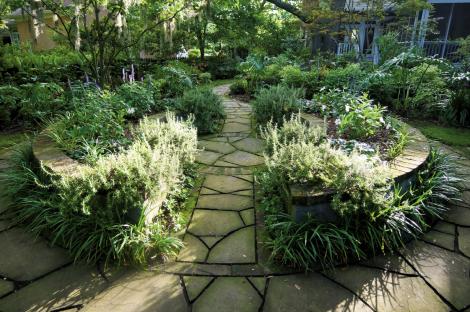 Well-Rounded: This raised garden is the centerpiece to the four garden rooms. The joints between the bluestone pavers were left “tooled” (ungrouted) to allow for moss or plant growth.