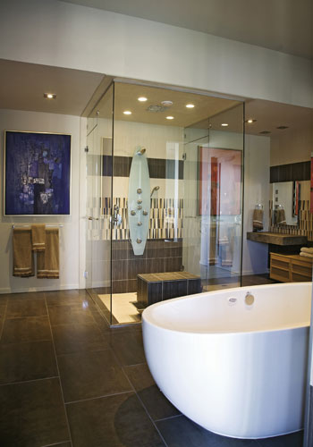 At Ease: The master bath features a soaking tub and a pair of Bertha Schwartz paintings