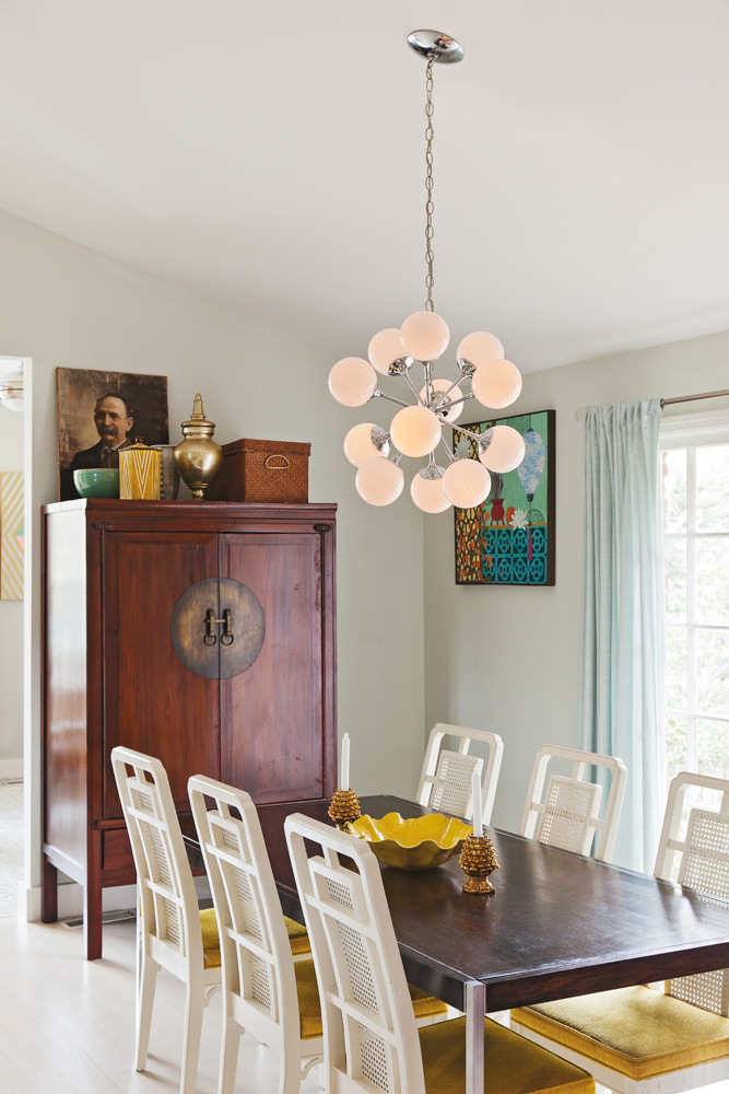 EAST MEETS WEST - Chinoiserie, artwork, and other prized pieces—like the mid-century modern chandelier in the dining area.