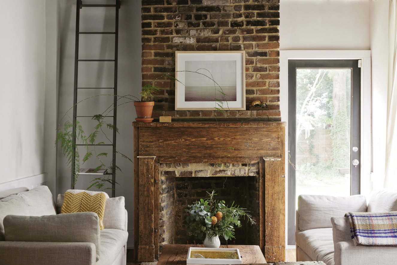 : Neutral furnishings and fresh greens establish a natural palette in the living room (above) that doesn’t compete with the simple beauty of the original fireplace. In the adjacent dining area