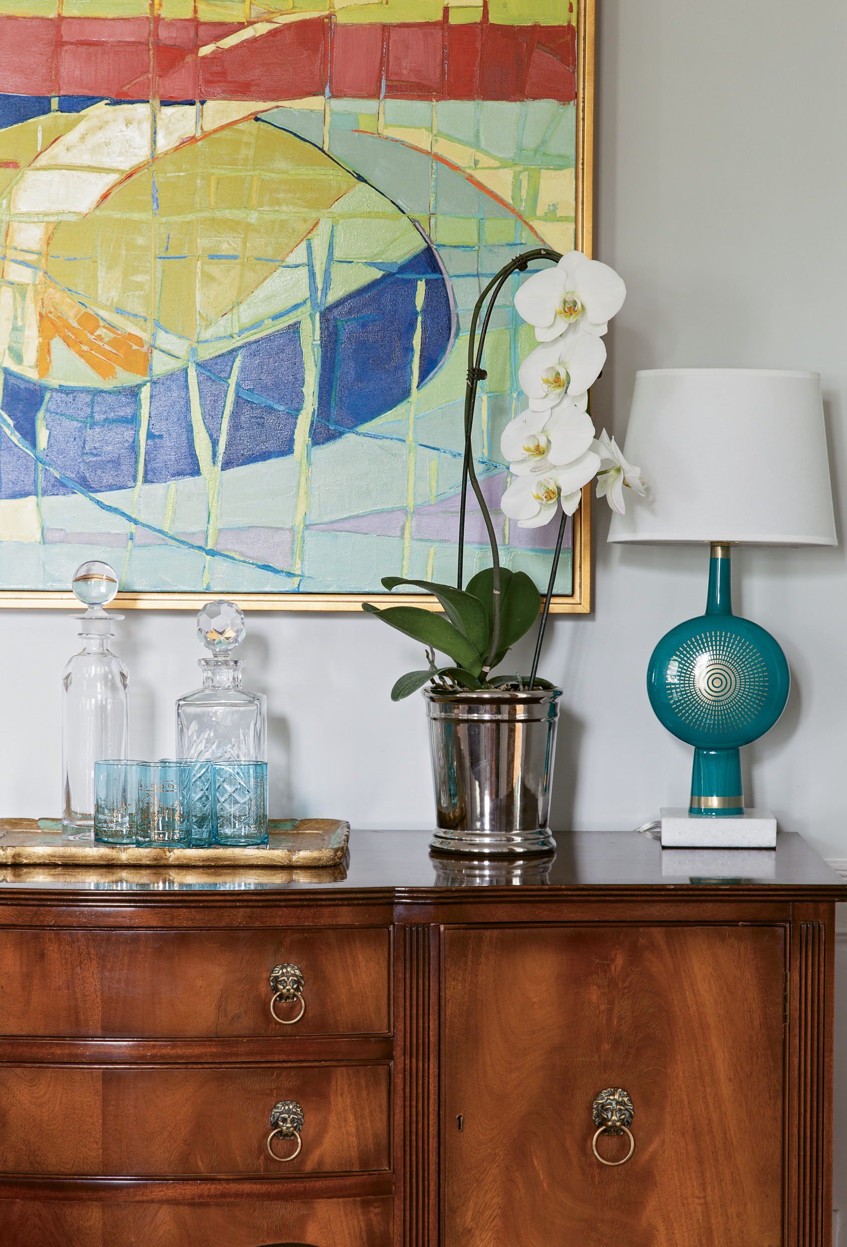 Shannon fell for this antique sideboard because its lion-head pulls mimicked the figurehead that has been mounted above the home’s entryway since she was a child living next door. The painting is by fellow Charleston Artist Collective member Ann Keane.