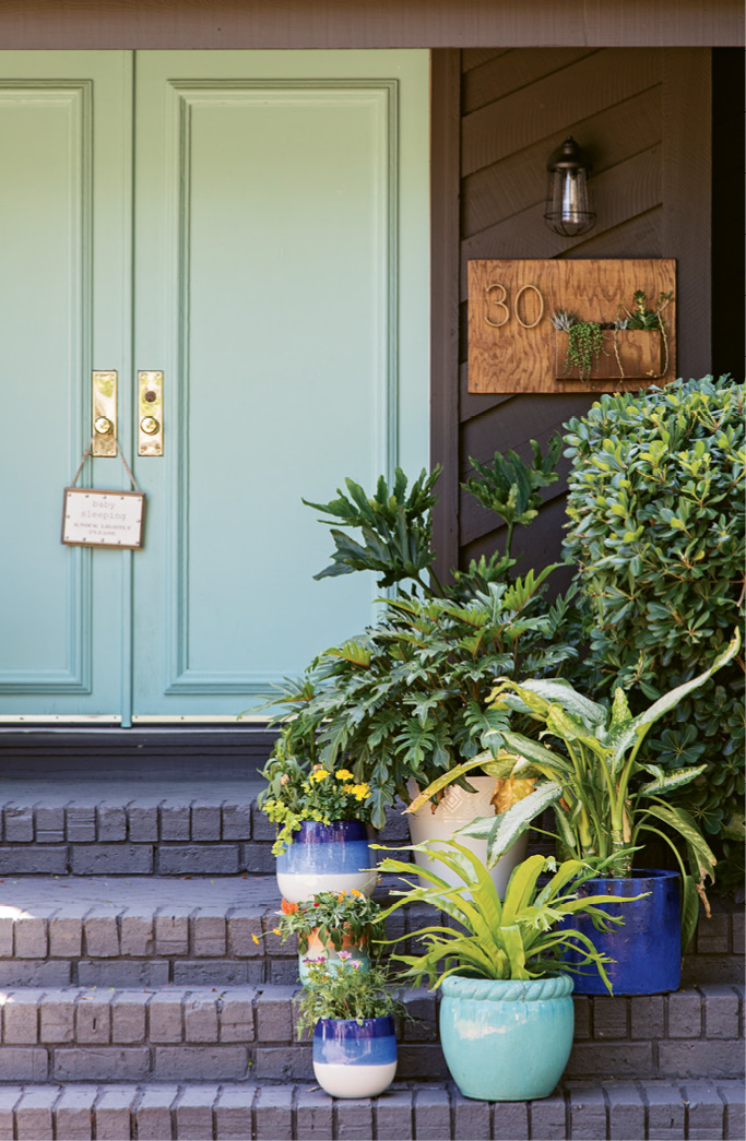 The brick exterior was transformed with a charcoal shade called “Ebony Fields;” and the front door was given new life with a few coats of “Tropical Bay,” a statement-making turquoise.