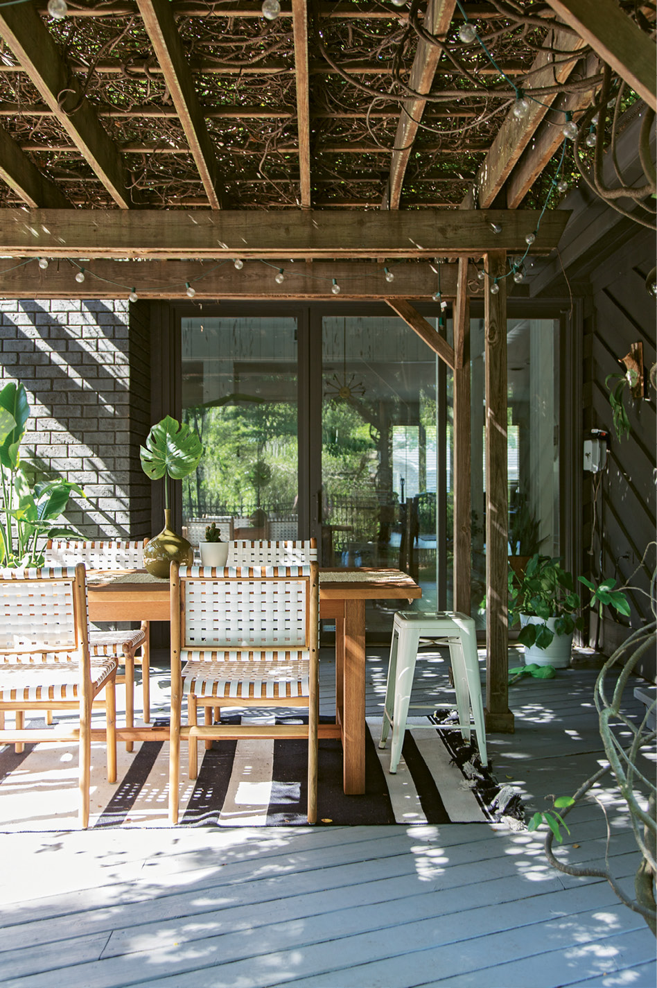 BACKYARD BLISS: Erin’s studio opens up onto the back deck; when the work day is done, she, Creighton, and the kids head to this spot for family dinners and dance parties.