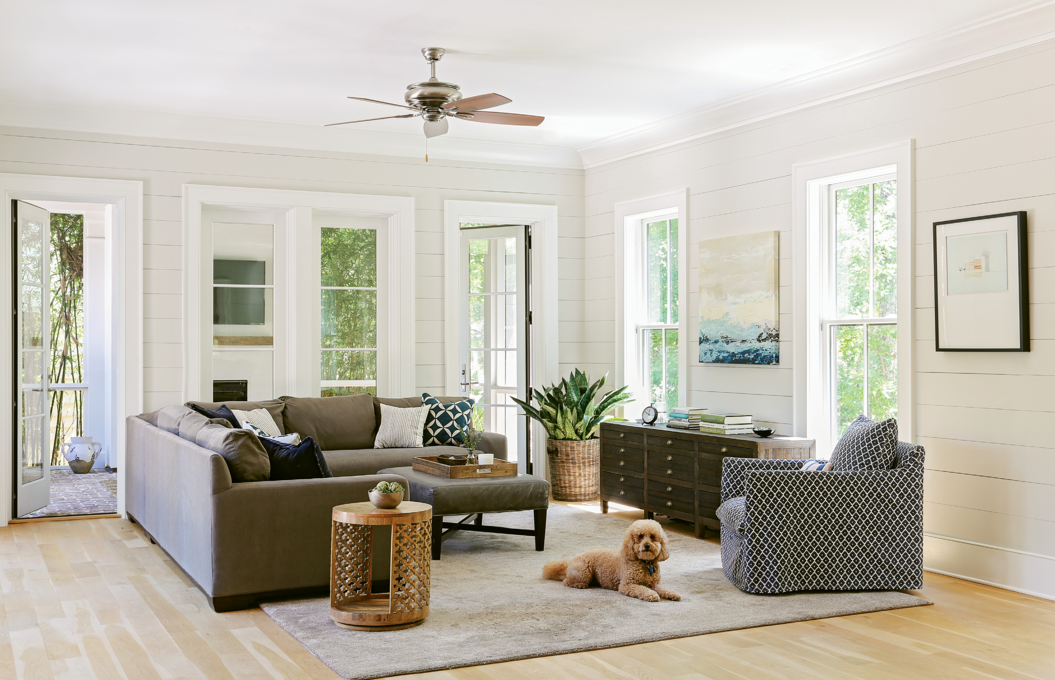 Lap &amp; Light: Shiplap walls throughout the main living and dining rooms give a “buttoned-up” feel to the casual décor, says Lenox. Loads of natural light energize the airy rooms, and a calming palette of soft greys adds a sophisticated feel.