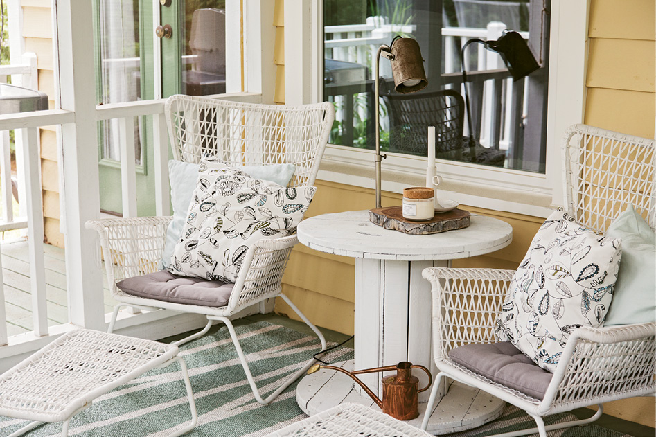 IKEA chairs and a side table fashioned from an upcycled electric spool make for another inviting outdoor nook