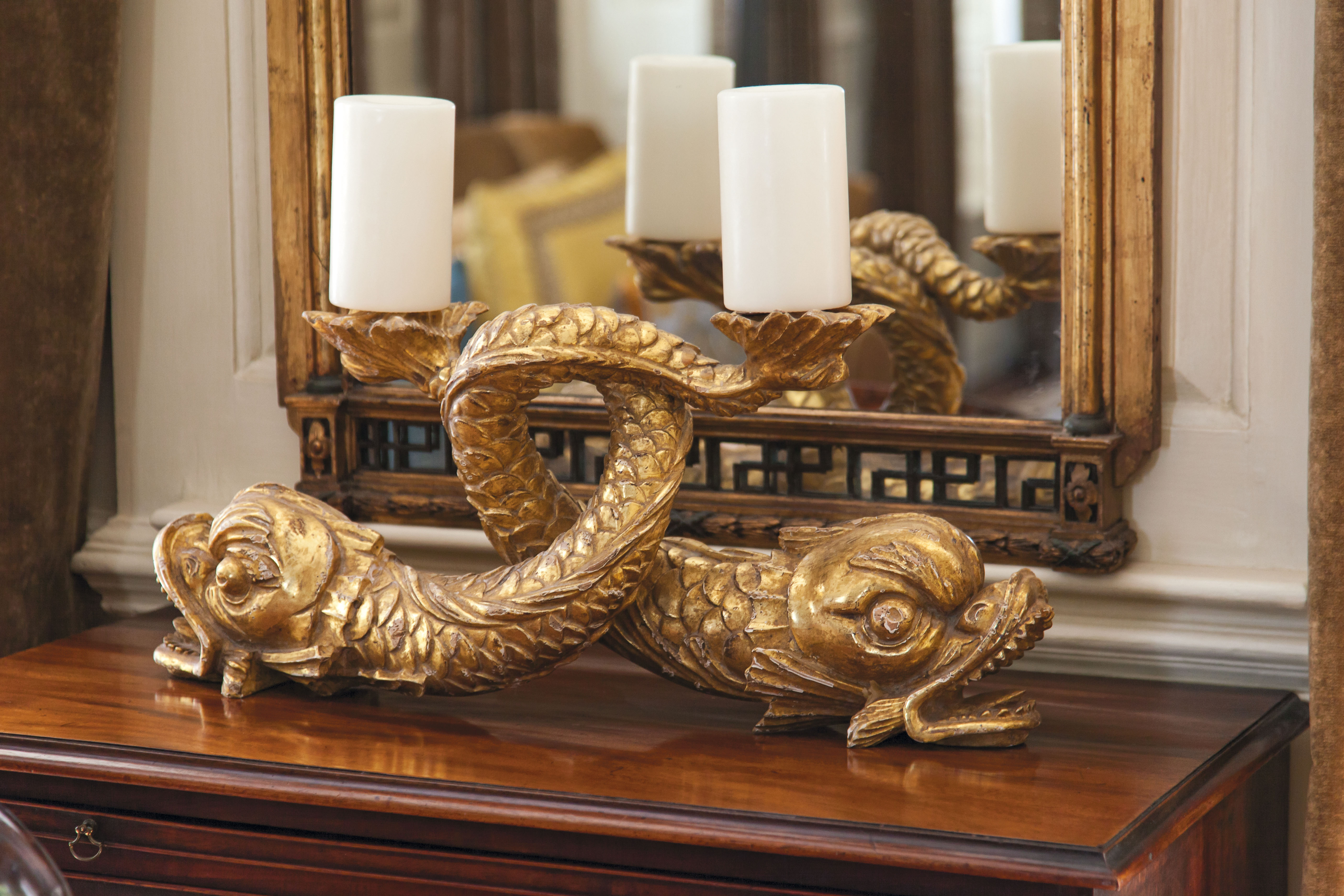 Circa-18th-century stylized gilt dolphins found through G. Sergeant Antiques play nicely off the gold tones seen throughout.