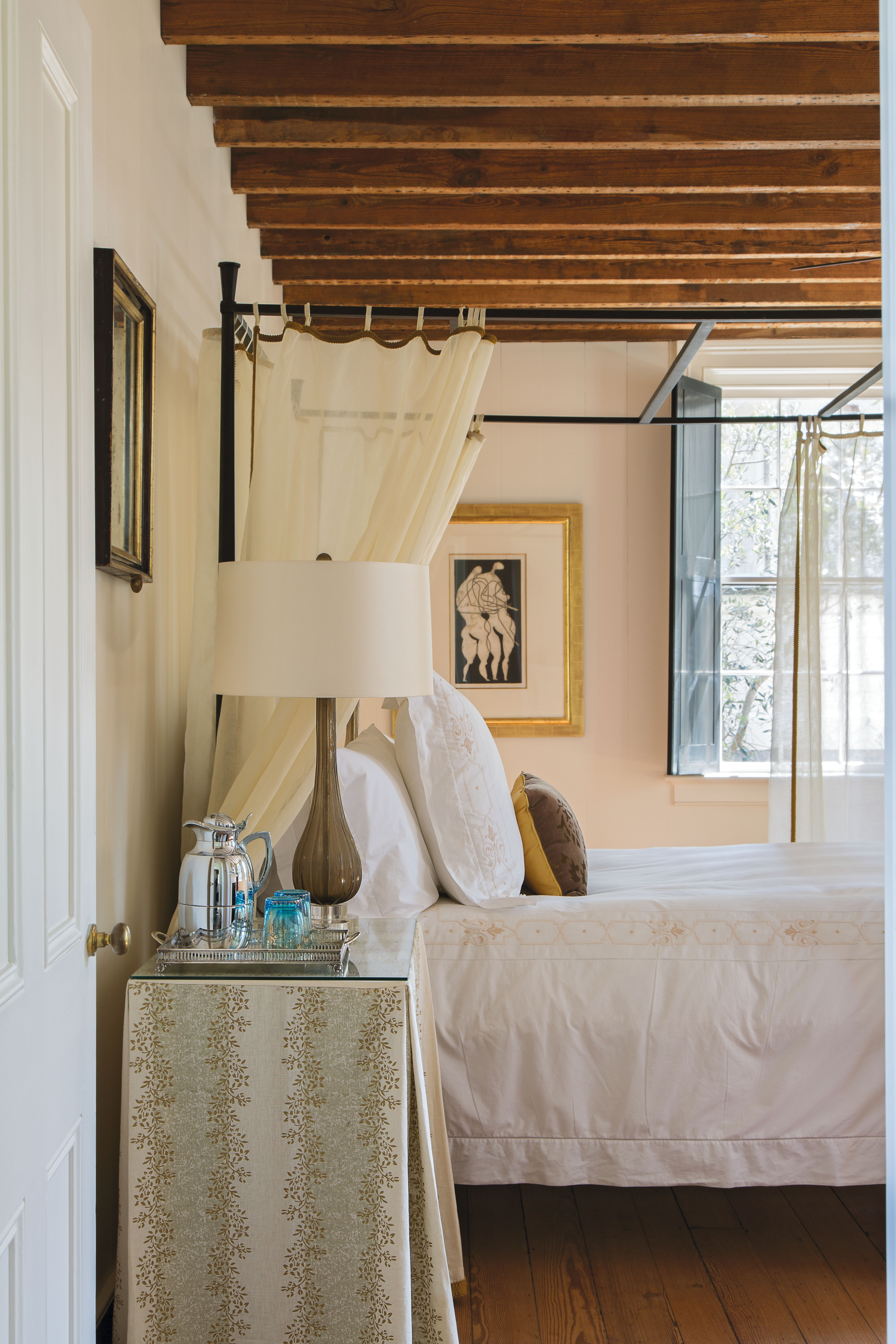 The guest quarters, located within what was once a detached kitchen house, feature original exposed wood beams and wood flooring, as well as more breathtaking artworks, such as Otto Neumann monotypes.
