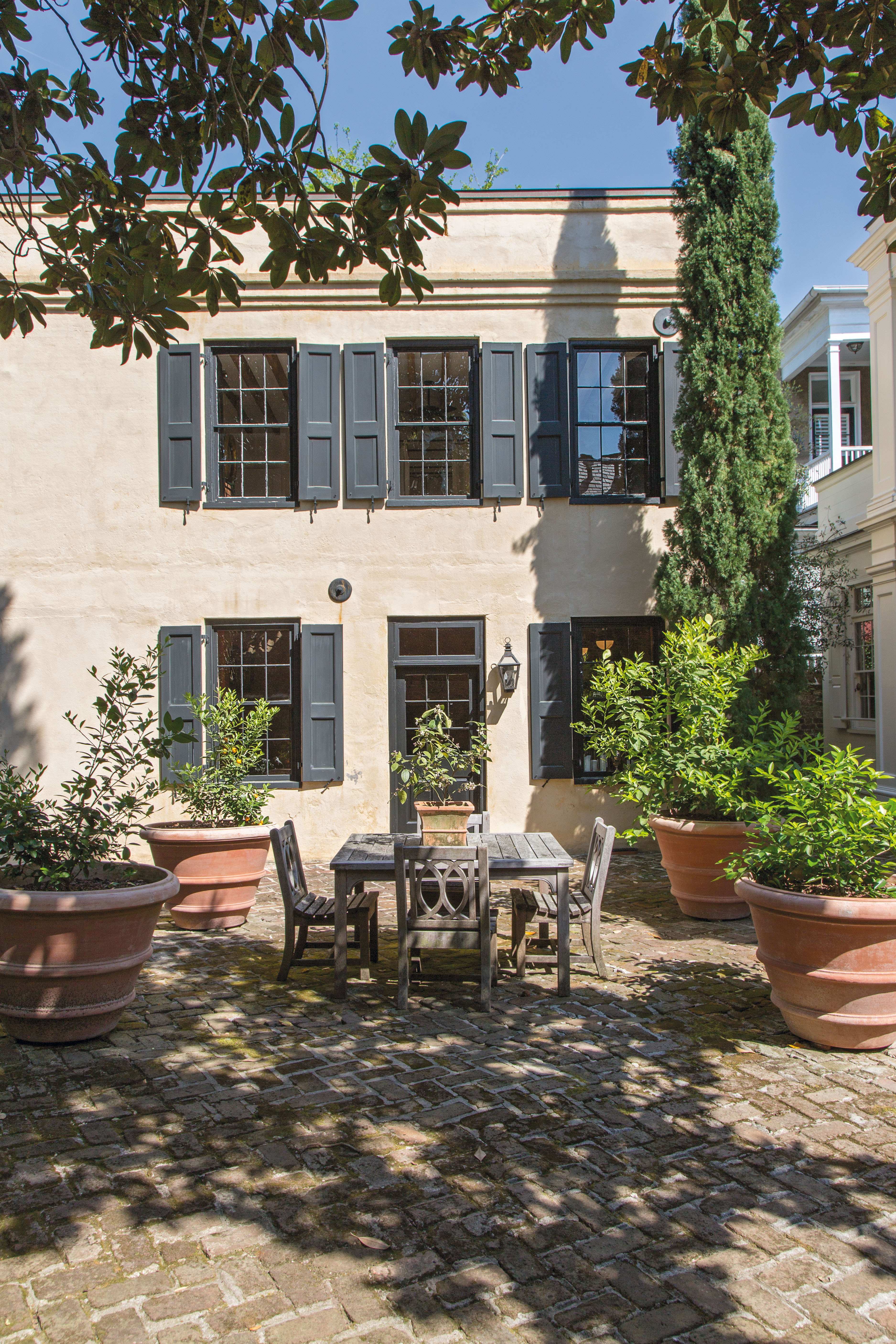 Sunny Spot: Located off the back courtyard with its potted citrus trees, the circa-1850 guest house has its own kitchen and living space.