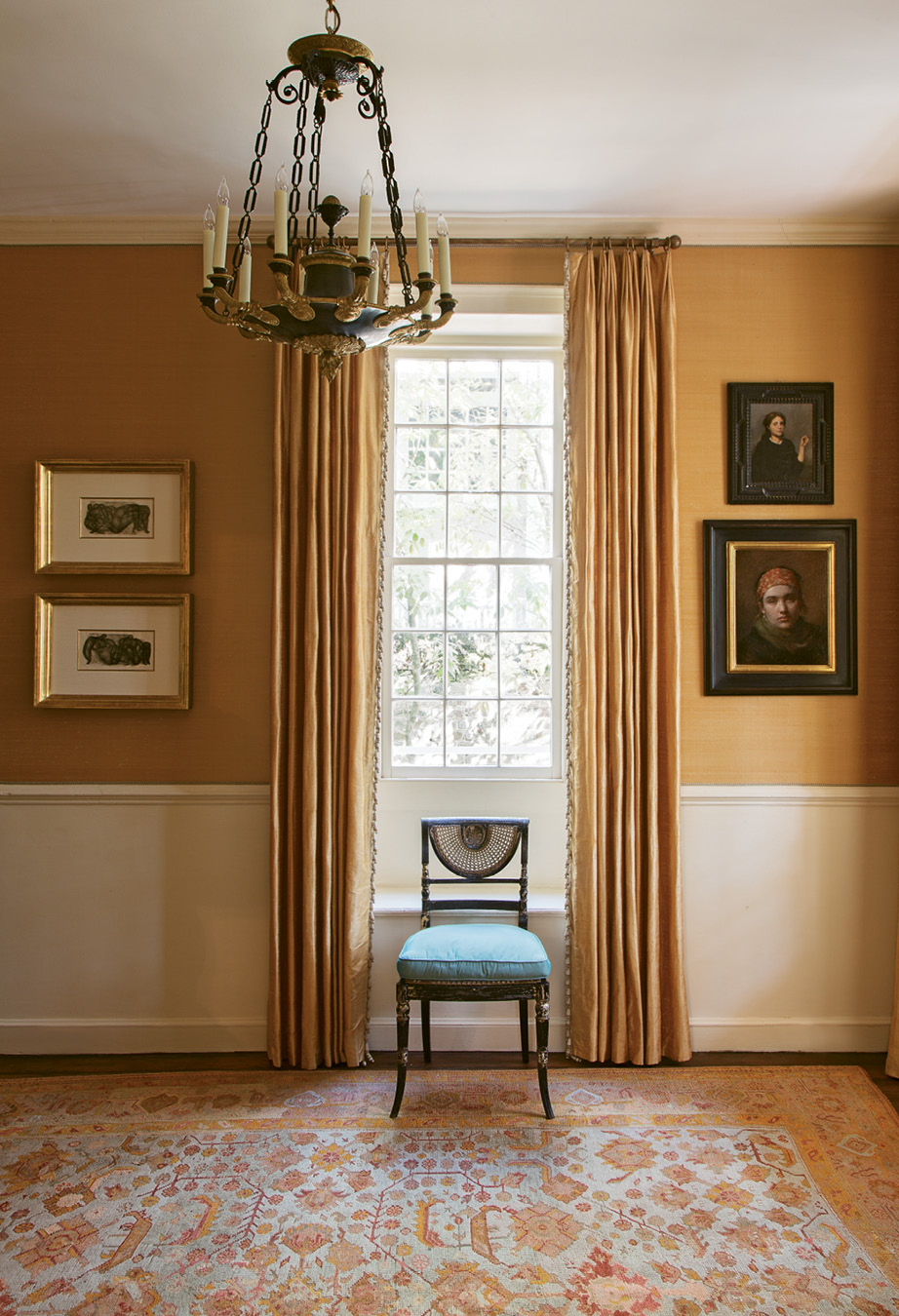 In the foyer, apricot-hued silk wall coverings and coordinating curtains provide an elegant backdrop for a pair of works by mid-century German Expressionist painter Otto Neumann and portraits by contemporary classical realists Daniela Astone and Charles Weed.