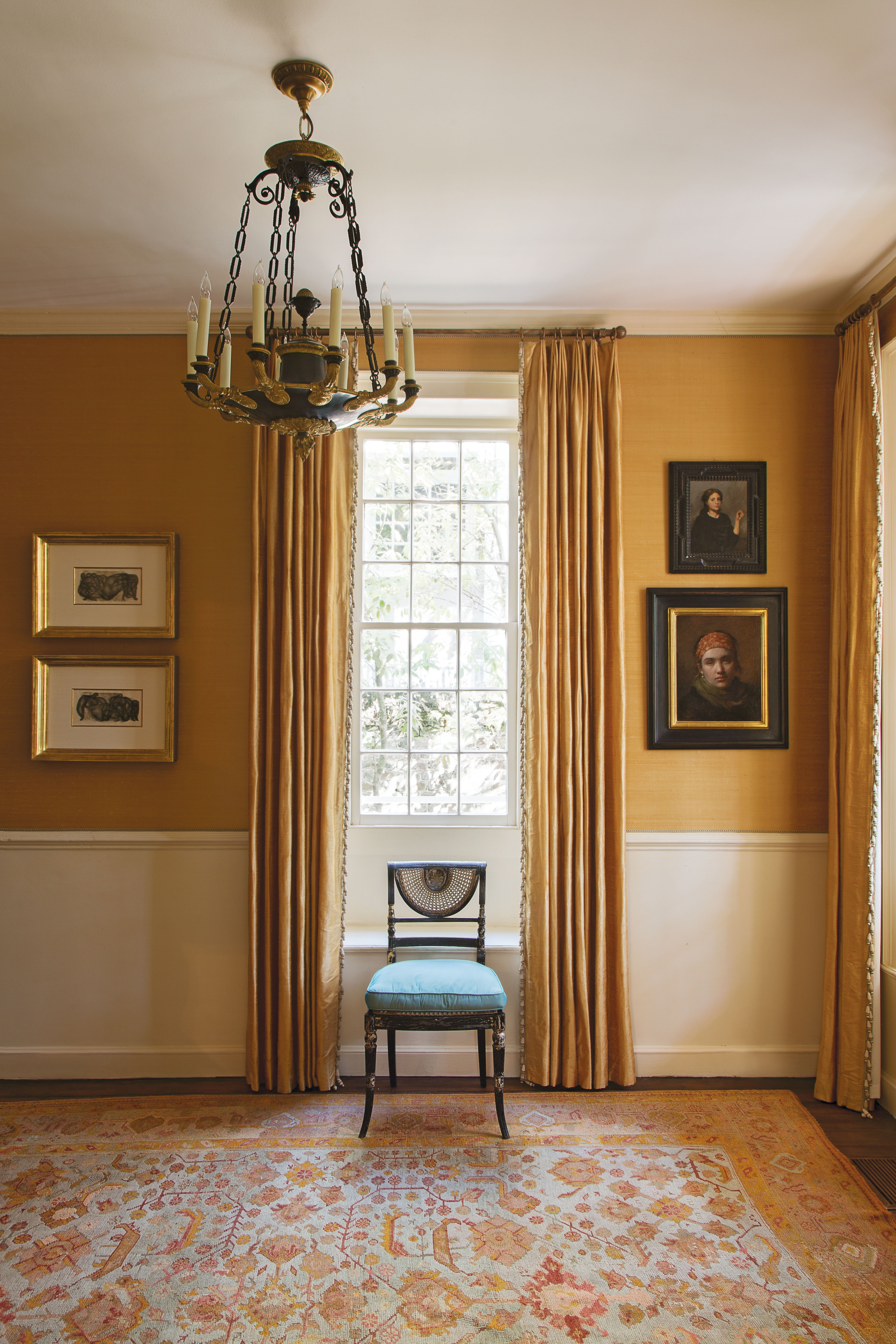 In the foyer, apricot-hued silk wall coverings and coordinating curtains provide an elegant backdrop for a pair of works by mid-century German expressionist painter Otto Neumann and portraits by contemporary classical realists Daniela Astone and Charles Weed.
