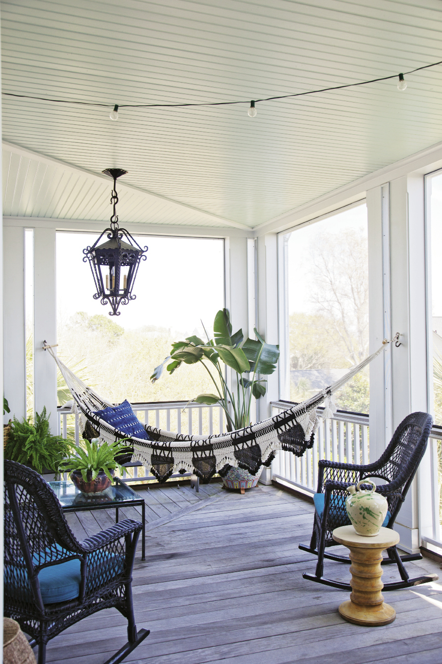 The screened-in porch, located just off the second-floor living room, feels like an extension of the interior. A hammock Lynne picked up in New York strikes a decidedly Bohemian note that’s balanced by the traditional silhouette of the iron light fixture.