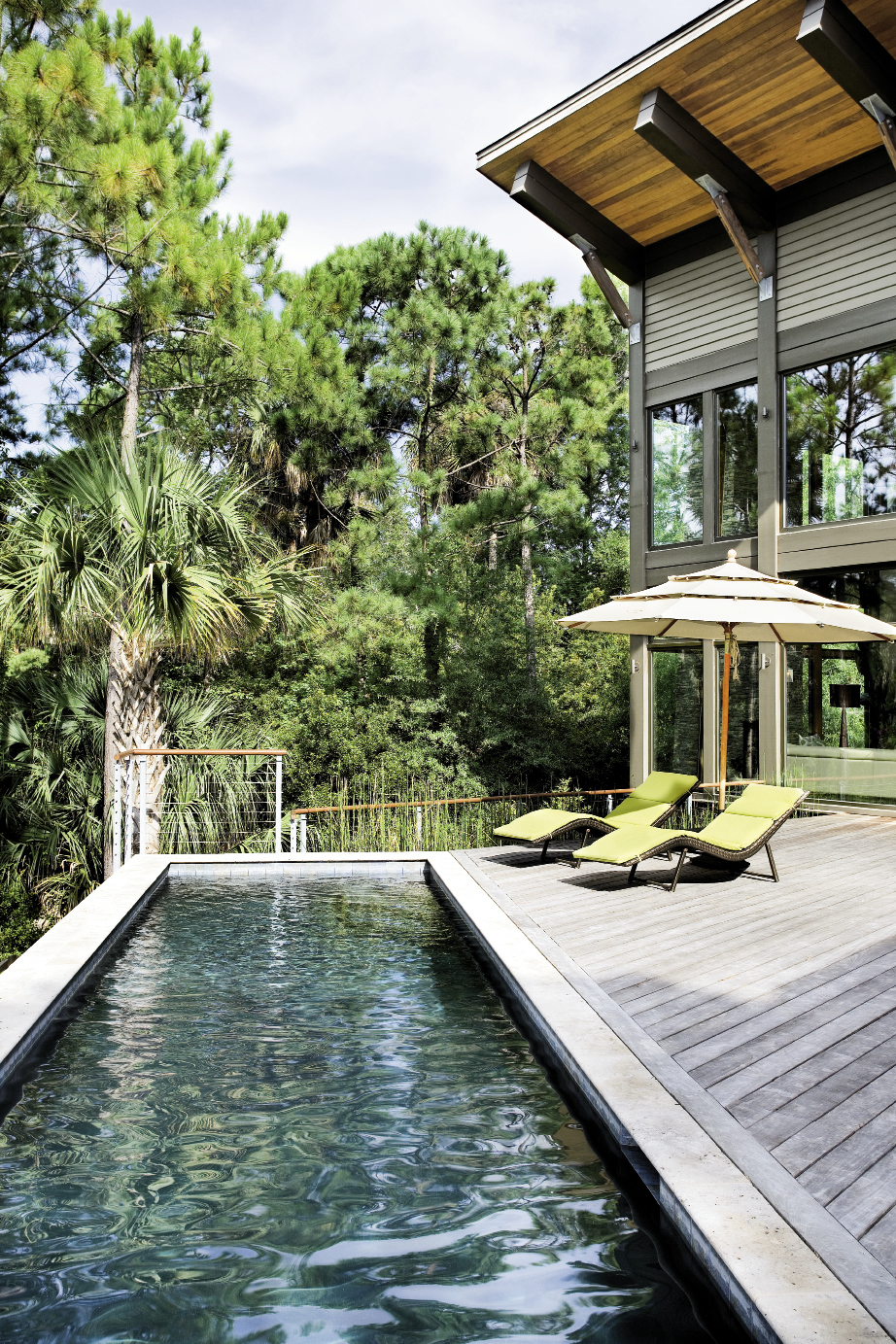 A 30-foot lap pool stretches across the expansive ipé deck and overlooks a quiet lagoon