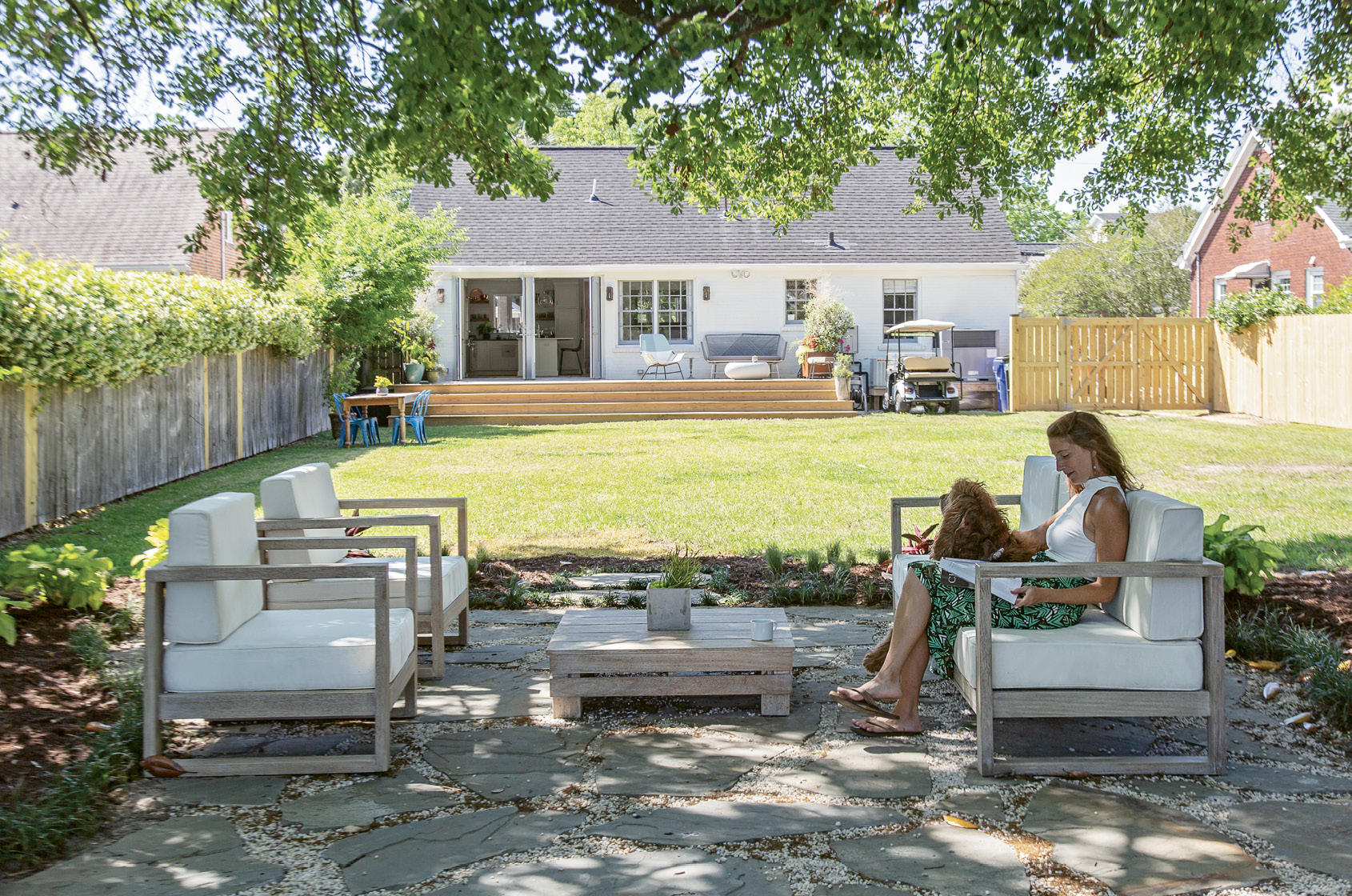 OUTDOOR OASIS: Two sets of French doors and a sprawling wooden deck add appeal to the rear of the home. But Rachel’s work out back has just begun. “I’m going to have big garden beds on both sides of the yard and plant more trees,” she says. “Then dreamland is to have a pool right in line with the patio.”