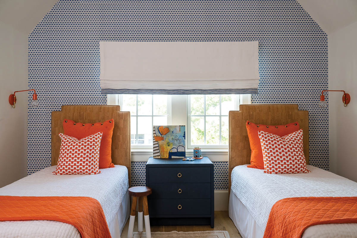 Orange Pop: Debby infused her own love of color into her grandchildren’s rooms. Thibaut’s blue “Denver” wallpaper in the boys’ room makes the orange Utility Canvas quilts and shams really pop.