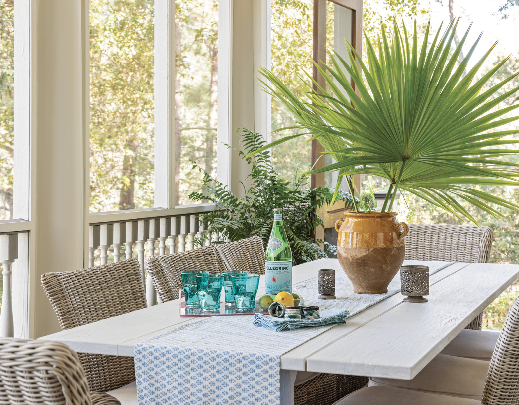 Outdoor Living: Part of the renovation focused on making use of underused spaces, and the 12-foot-deep porch off the main living room and kitchen area was a prime target. Elebash added outdoor furniture, including this Kingsley Bate dining table, and created the feel of a continuous space between the two rooms by integrating the color palette with green, blues, and whites.