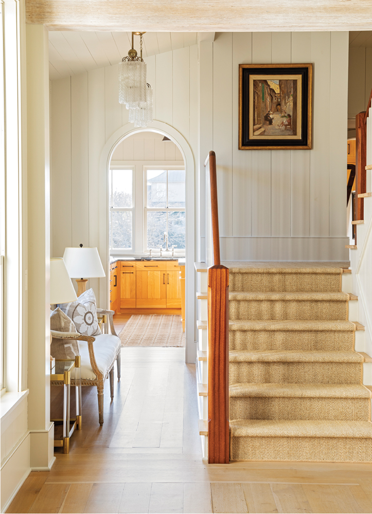 Inside, a cozy entryway warm white oak flooring leads to the kitchen, as well as the large, bright open-plan living space.