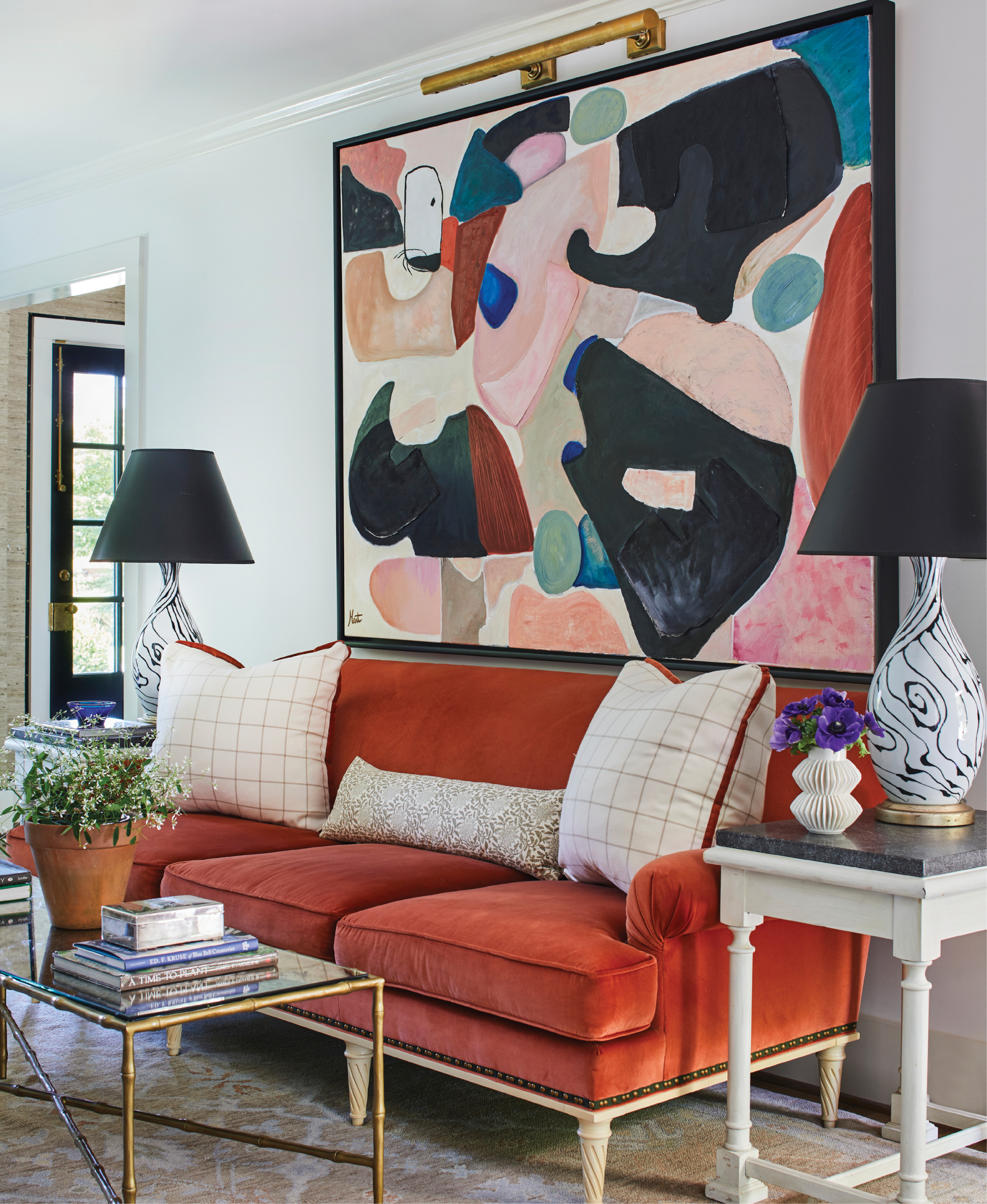 Make a Statement - A large-scale abstract painting by local artist and jewelry designer Hart Hagerty stuns in this Riverland Terrace living room. The art sits amid a vignette reflective of the home at large—a vibrant space where antiques mingle thoughtfully with modern art.