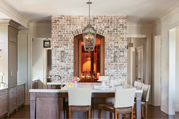 in the mix: Accent walls of brick and butted board help to set a welcoming, laid-back tone, while gilt-framed artwork and fixtures from Circa and Urban Electric add touches of elegance.