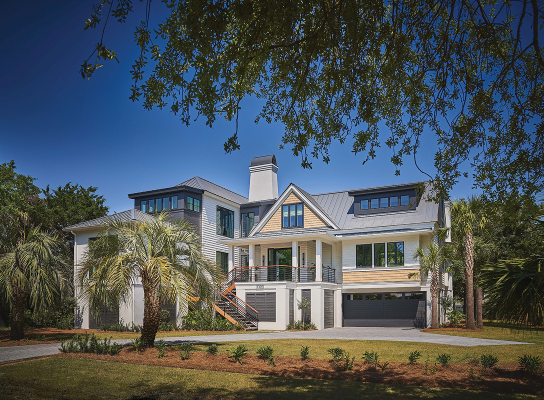 This modern family home pays homage to the traditional architecture of Sullivan’s Island while adding a contemporary twist. Classic gables and shiplap coexist with sleek black accents and floor-to-ceiling windows to create a comfortable yet effortlessly cool space for real estate developer Chris Riley and his two children. The designer sourced the outdoor furniture from Restoration Hardware and Four Hands.