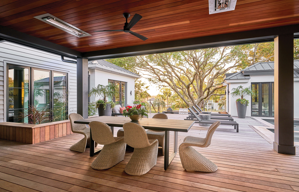 Sliding glass doors open the poolside seating area to the kitchen, and an alfresco dining room is just beyond the main living room.