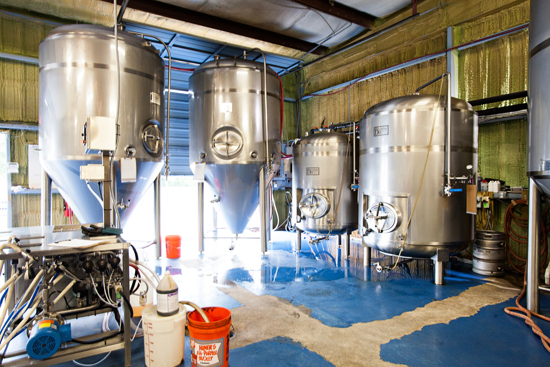 The brew floor, keg washer, two fermenters, and two bright tanks.