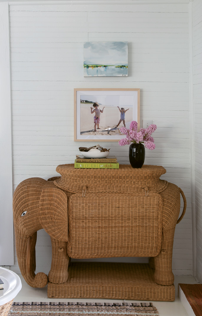 Unique finds, such as the vintage wicker elephant bar and the 1940s driftwood inspired table lamps, dot the home.