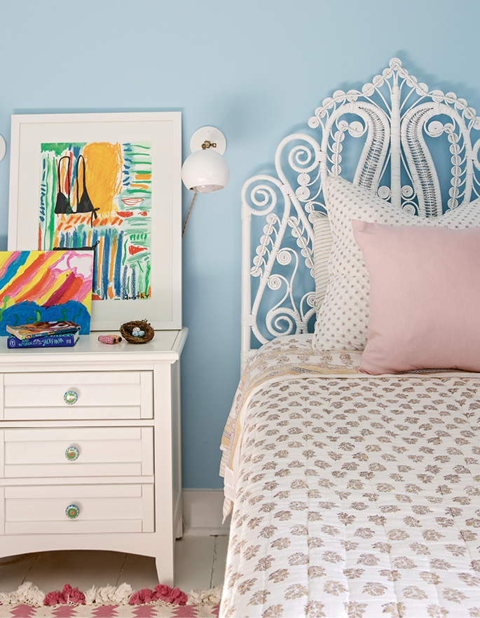 A headboard and rug from Serena and Lily lend a touch of girlish charm to the daughter’s bedroom.