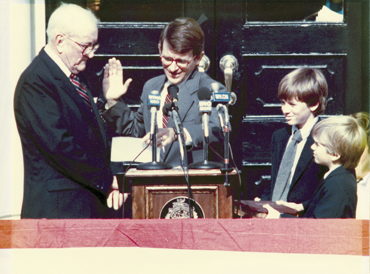 Mayor Riley has taken the oath of office a record 10 times. He’s pictured here in 1984 (his third term), with his father, Joseph P. Riley, Sr., administering the oath, and his sons, Joseph and Bratton (far right), by his side. When Joe III did the honors for his father in January 2012, he inserted some humor by beginning the oath with, “So, for the last time….”