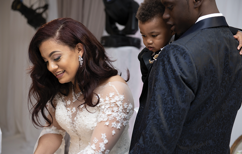 Chris, holding son CJ, and Mariana at their wedding in February 2019