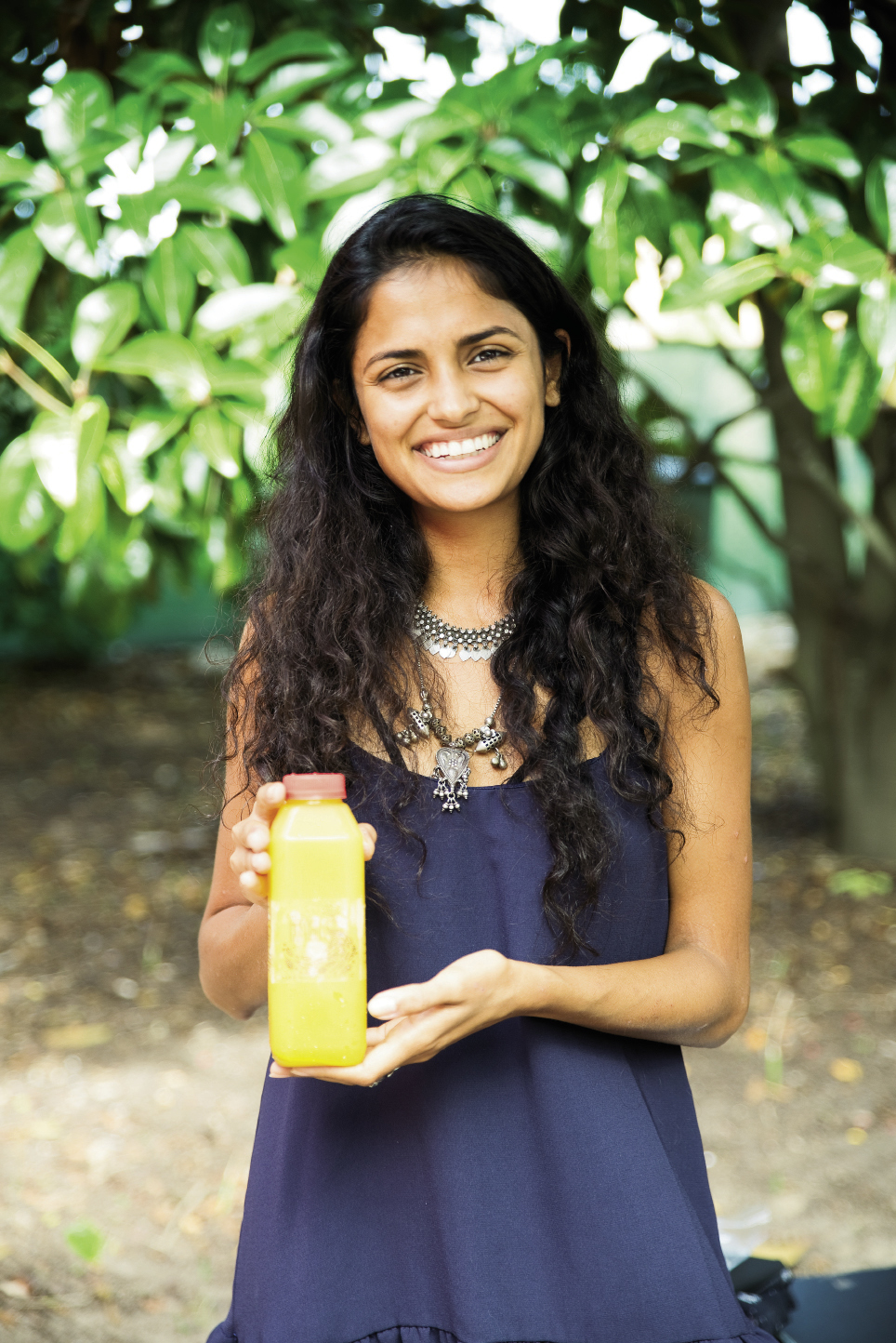 Ruchi Mistry of Huriyali Juices shows off a bottle of her company’s cold-pressed juice made daily
