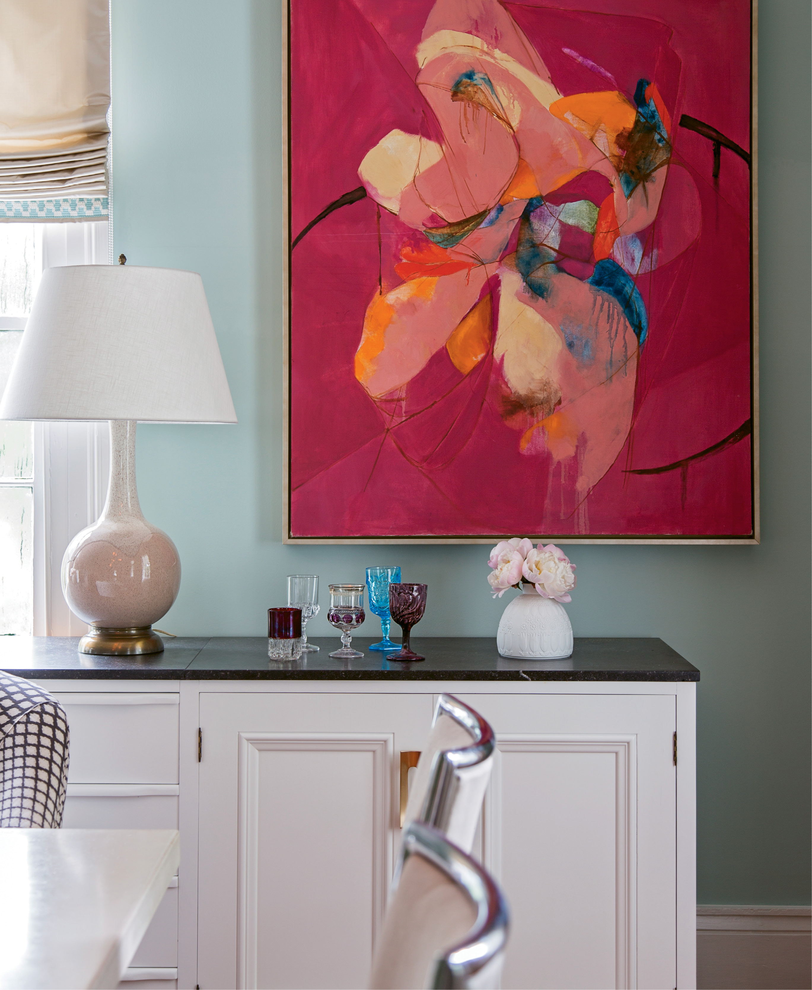 In the Old Village, a family of Brooklyn transplants revives a historic abode with their youthful energy and vibrant art collection, which includes the likes of this mid-century floral painting scored at High Point Market.