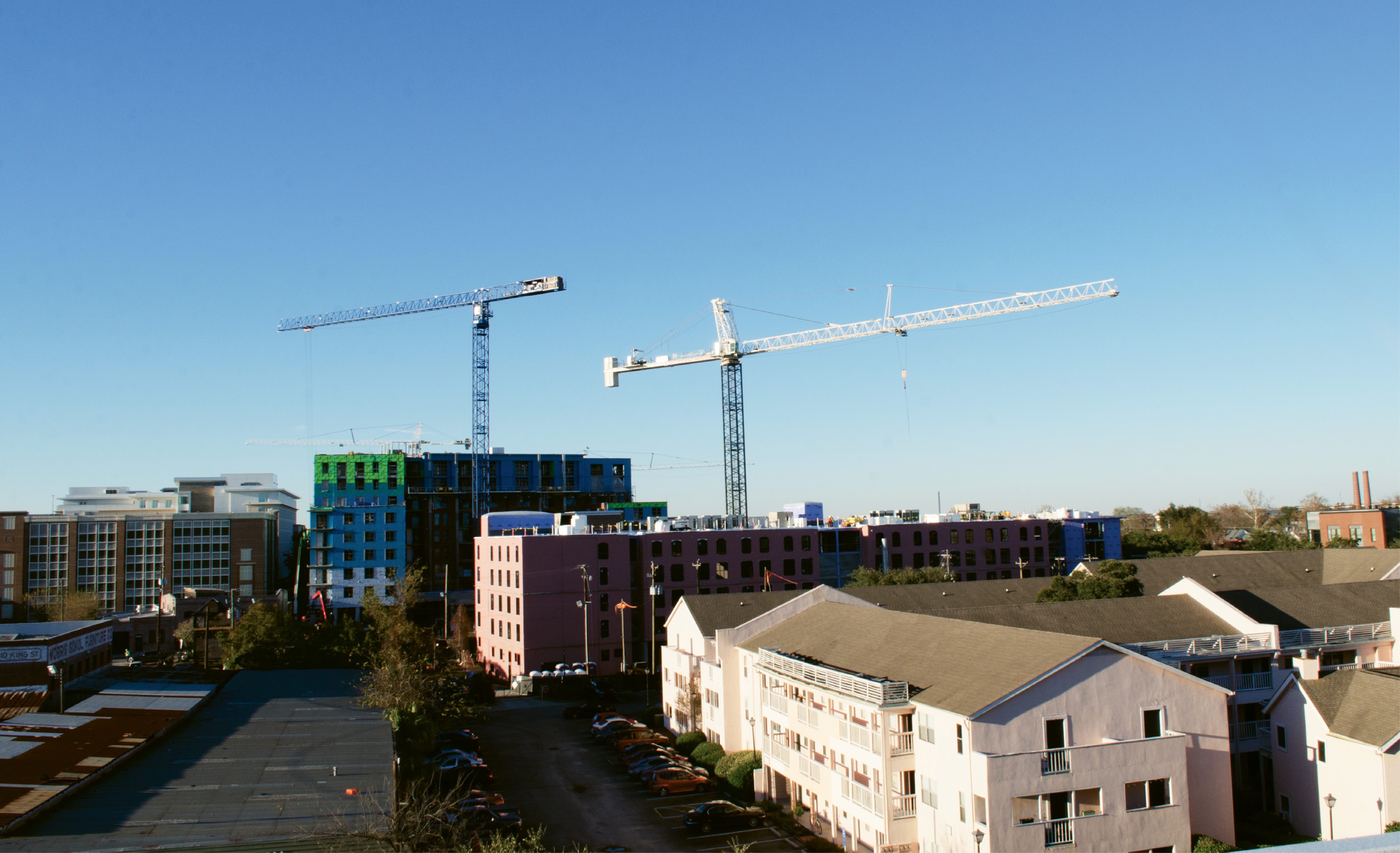 For a few years, construction cranes have dominated the downtown skyline. At right is the Courtyards at 411 Meeting Street complex, under-market rental apartments that are slated to become a 300-room hotel.