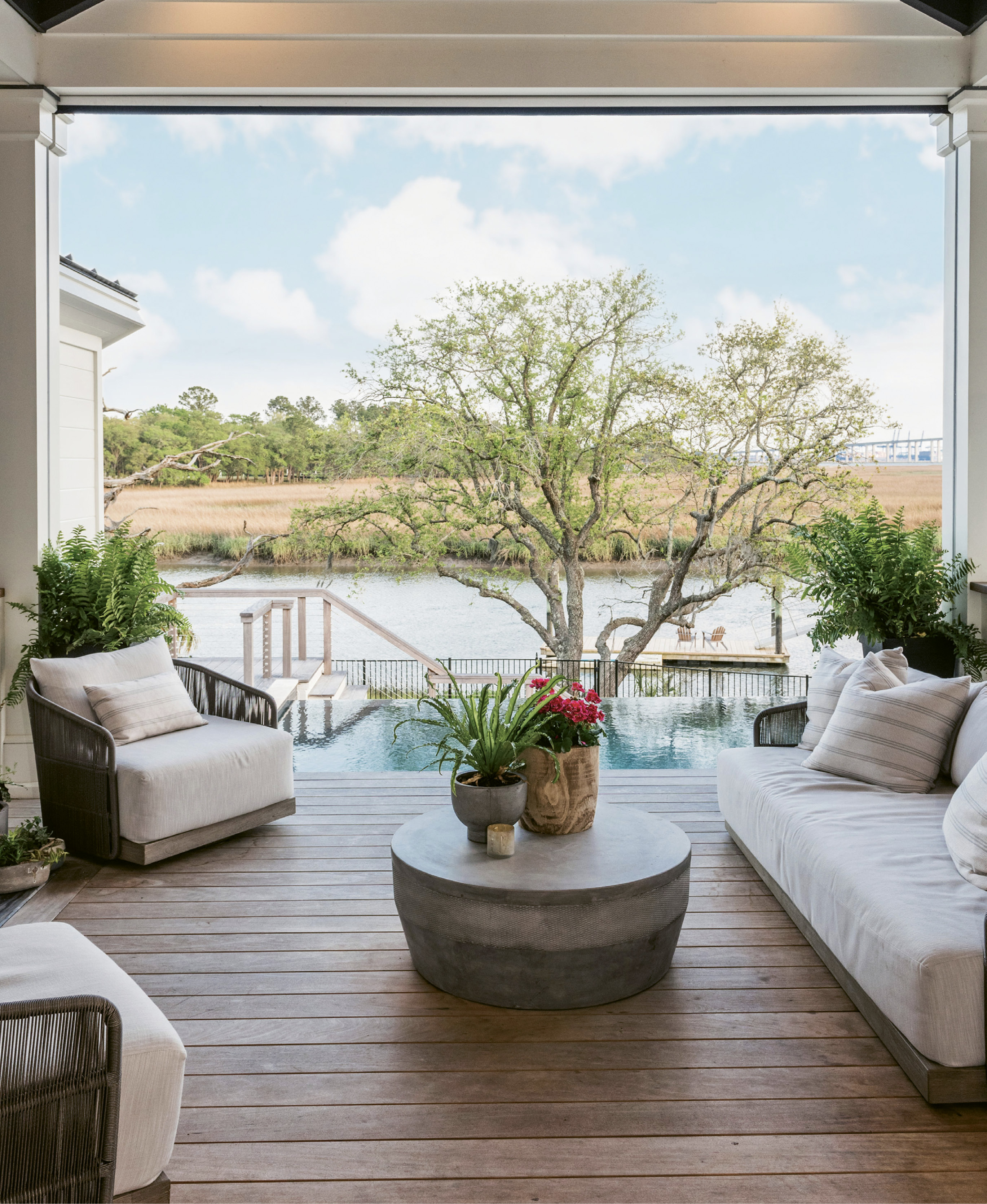 The comfortably appointed covered back porch overlooks the pool and Ralston Creek.