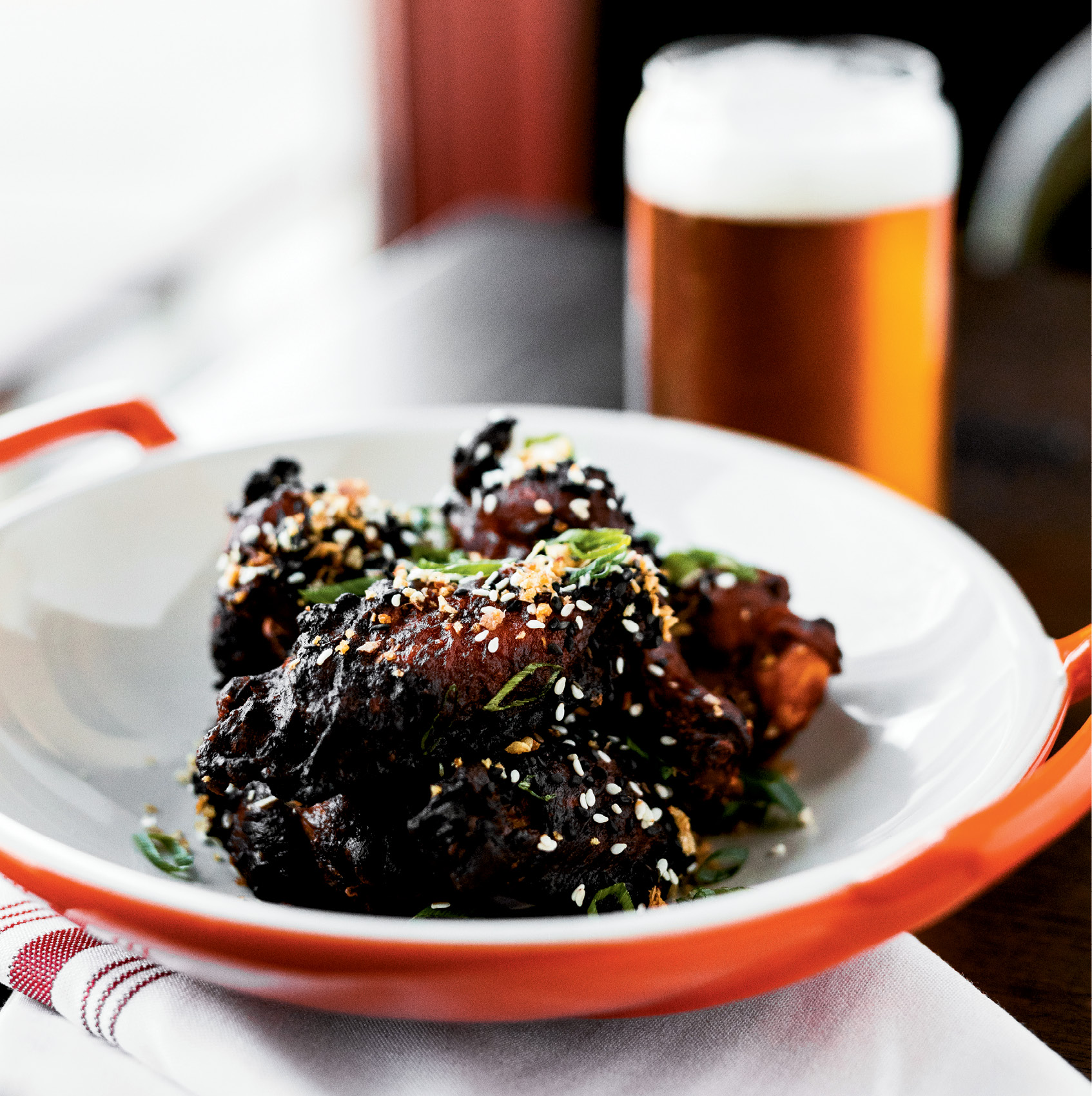 Clever Classics: Chicken wings are revamped with Korean mustard, ginger, fried garlic, and sesame seeds.