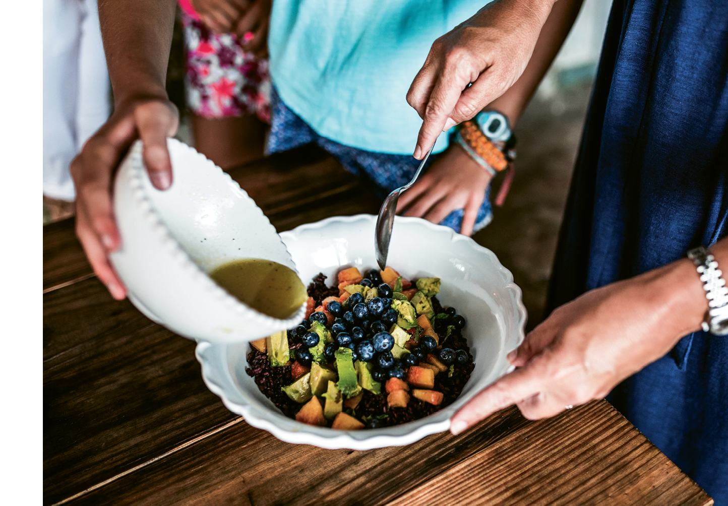A salad of chilled black rice, mango, peaches, blueberries, avocado, and honey vinaigrette is a refreshing dish for the end of summer.