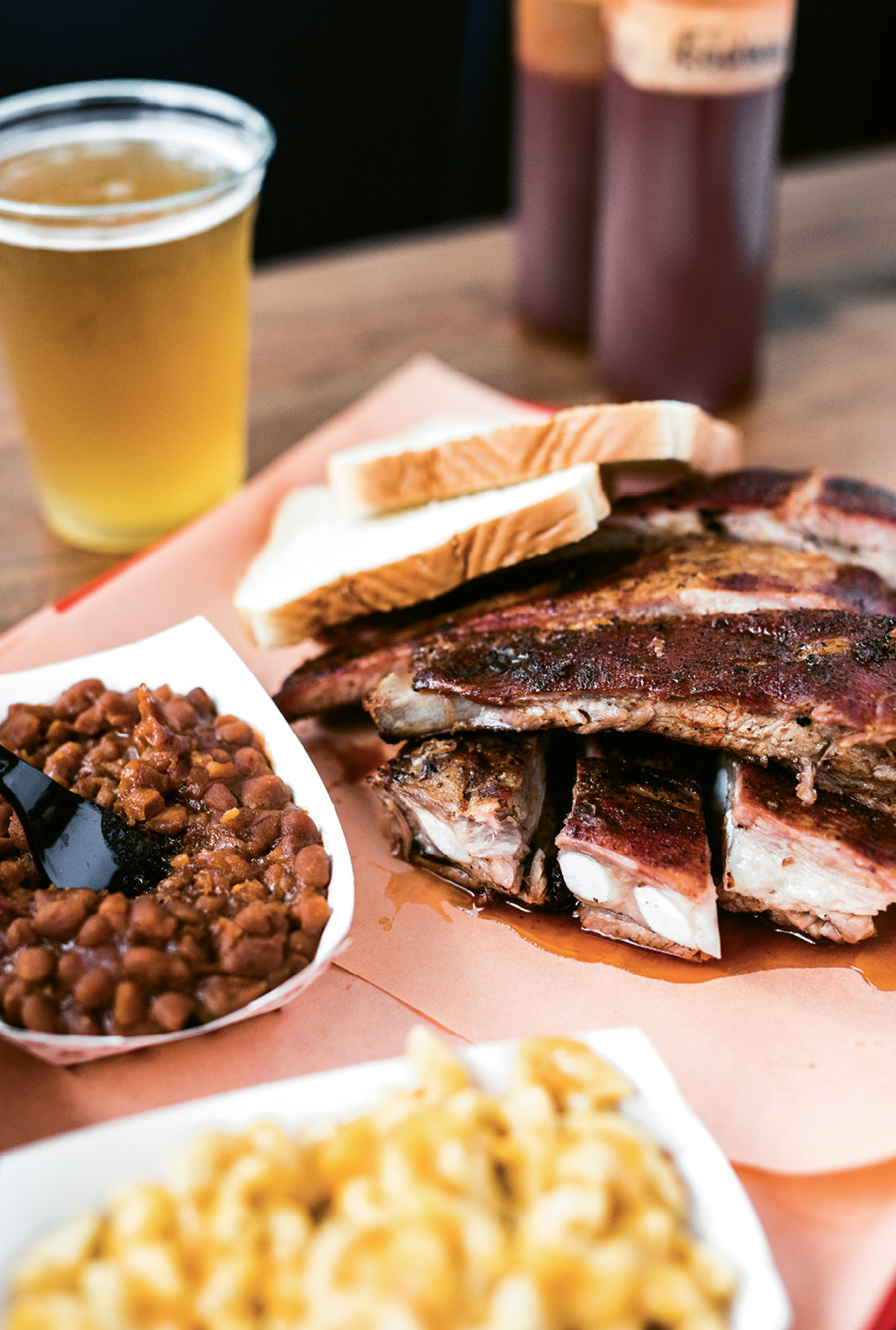 A plate of smoky ribs, sugary baked beans, and mac-n-cheese.